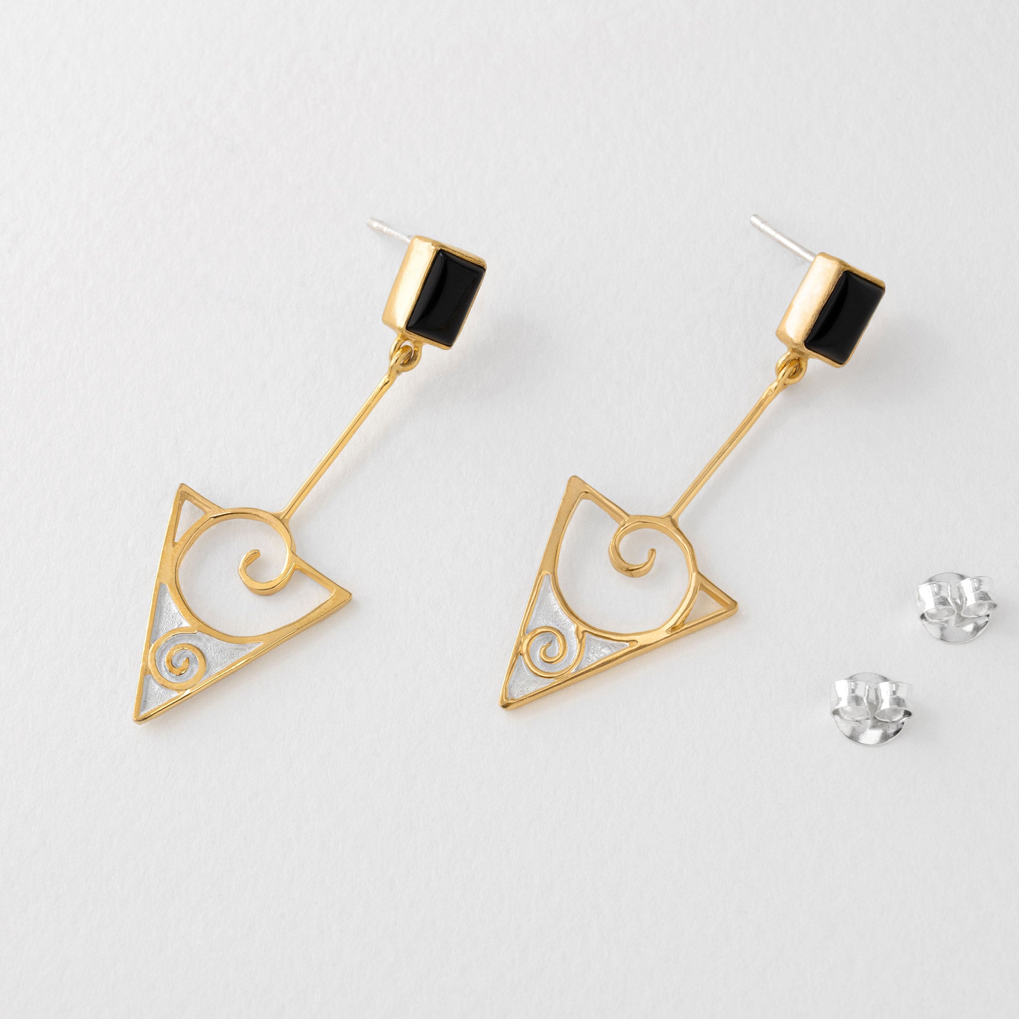 Gold drop earrings with swirling triangle design and black onyx inspired by Gustav Klimt