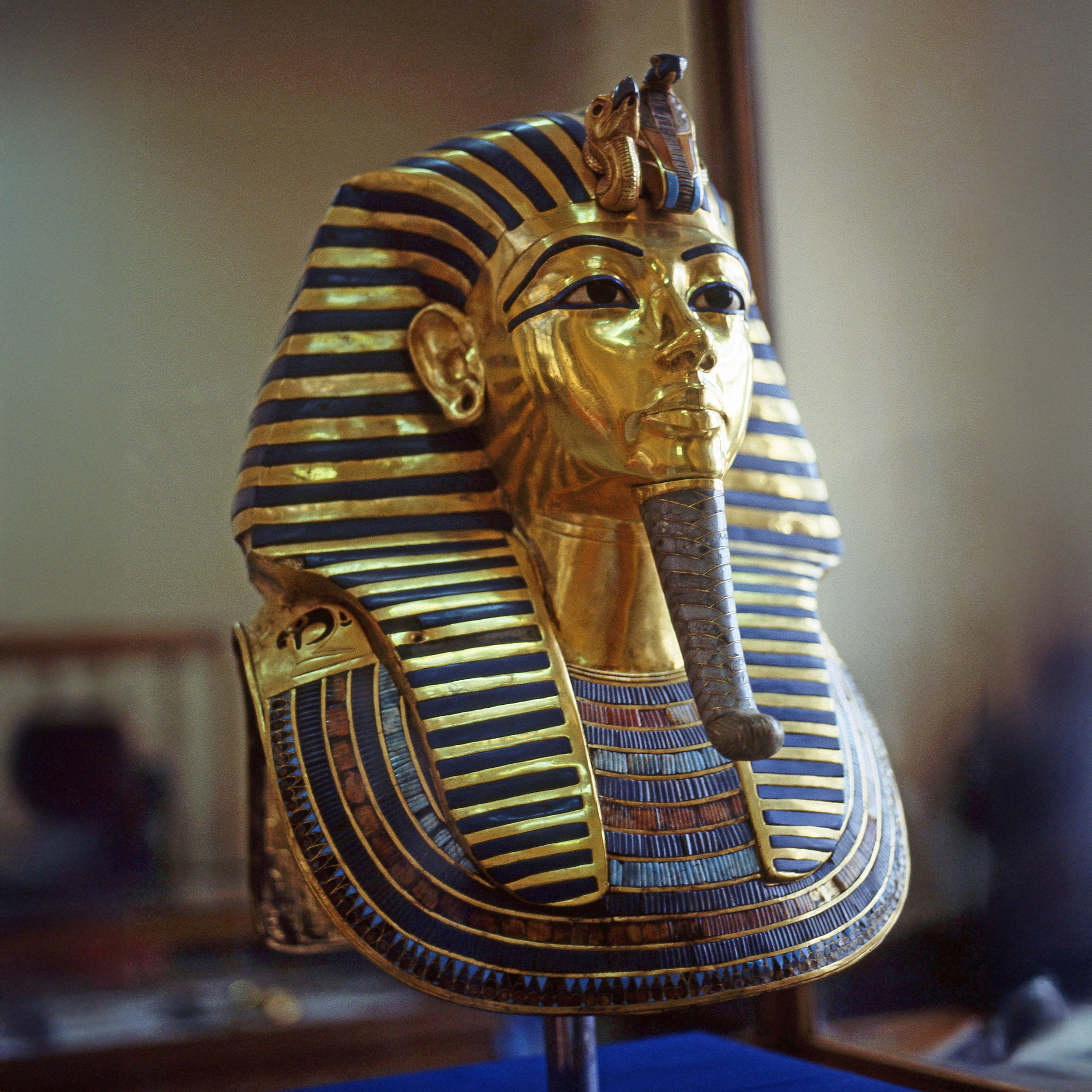 Ancient Egyptian golden pharaoh funerary mask with blue lapis inlay.