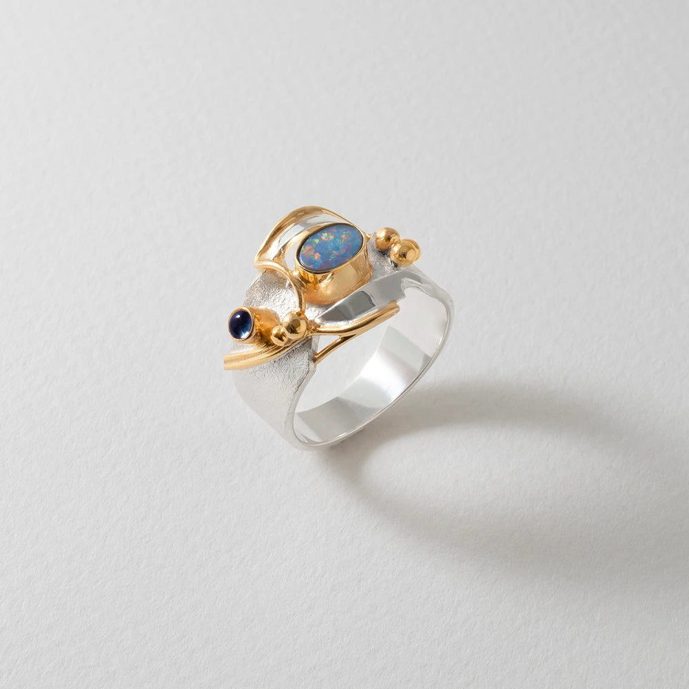 Ring with gold and silver featuring an opal stone