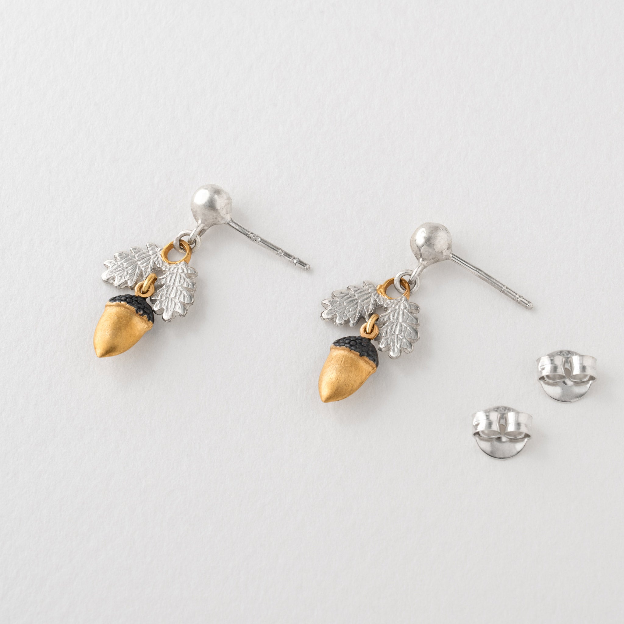 pair of acorn earrings in sterling silver and gold
