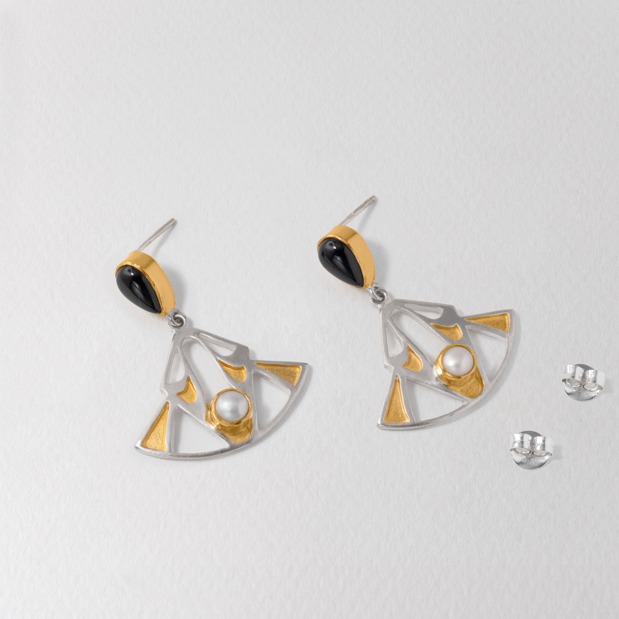 Elegant geometric Art Deco earrings in 925 silver and gold with a pearl centres and bold onyx gemstones.