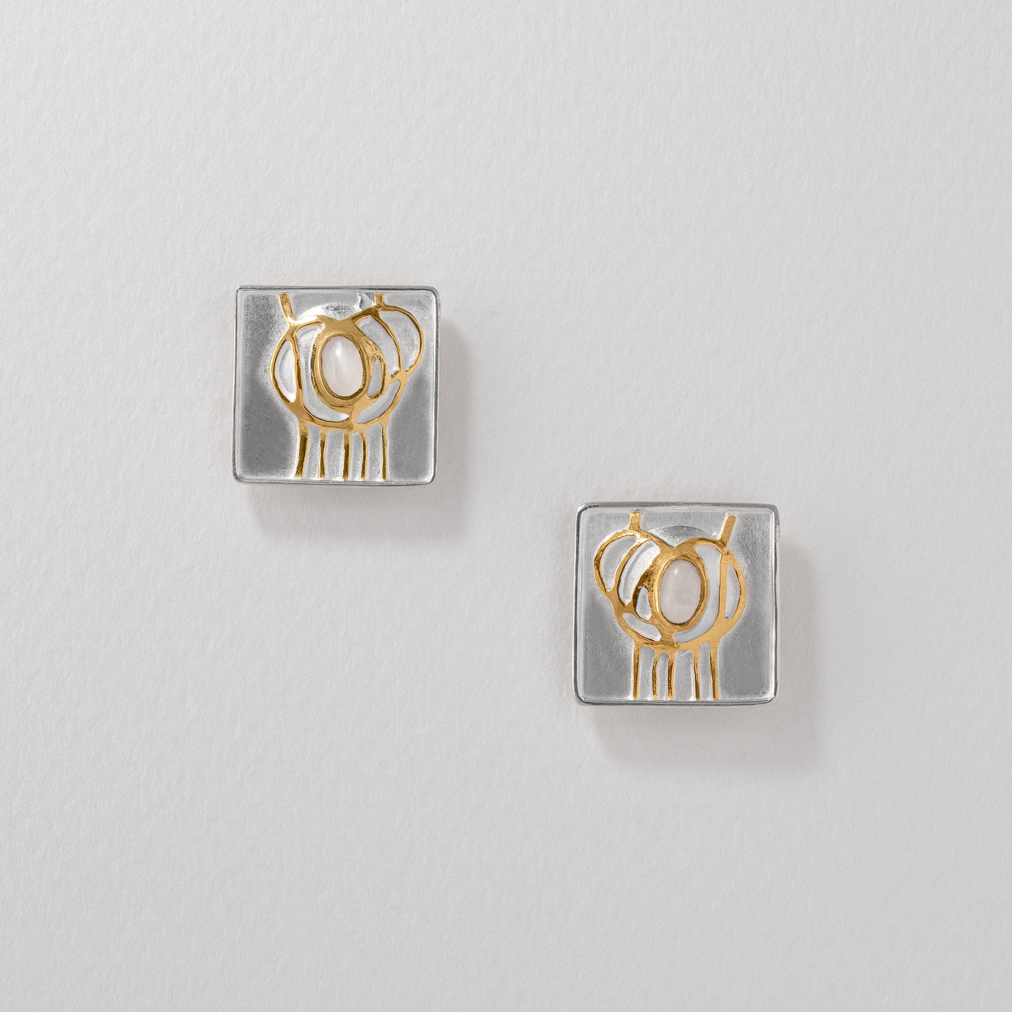 Sterling silver and gold-plated Mackintosh earrings featuring elegant moonstone detail.