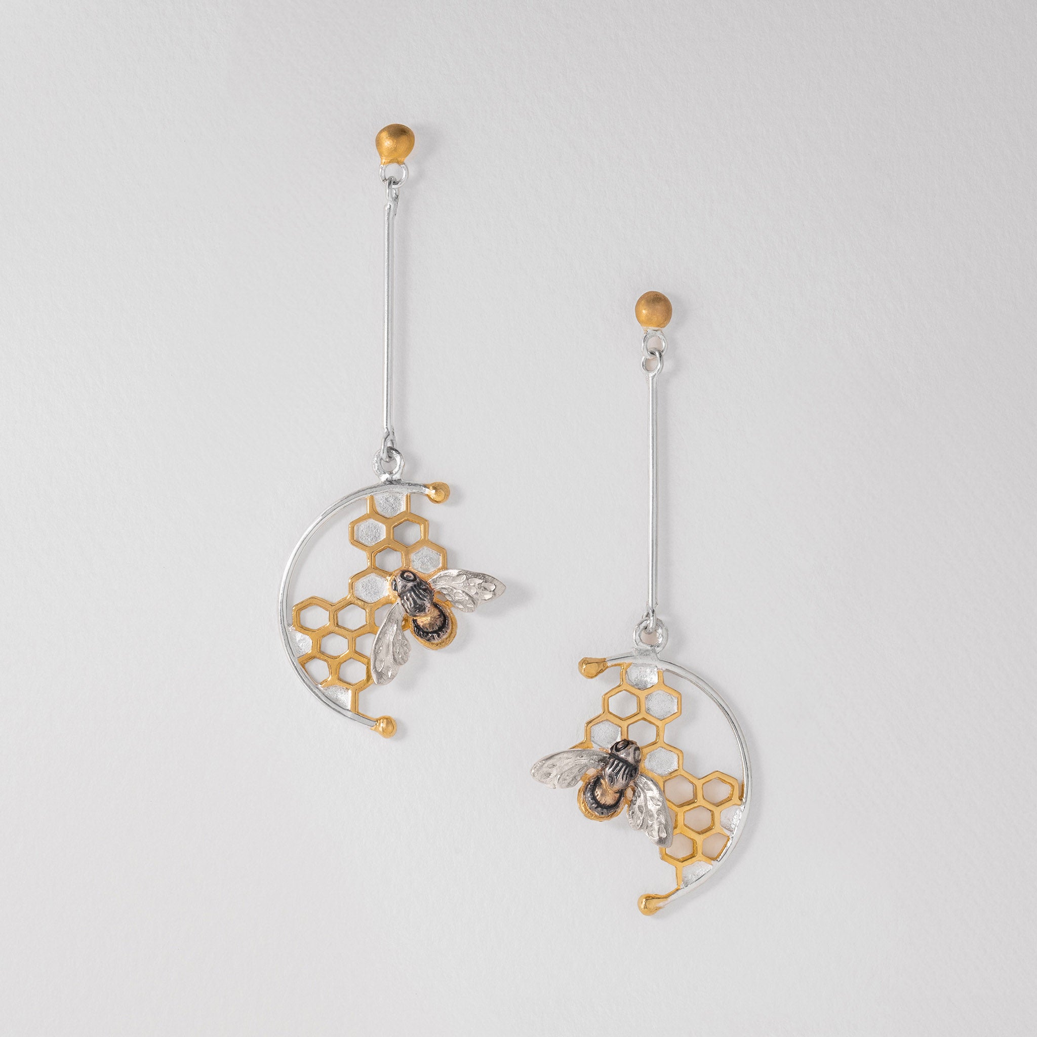 Sterling silver and gold-plated honeycomb earrings featuring intricate honeybee motif.