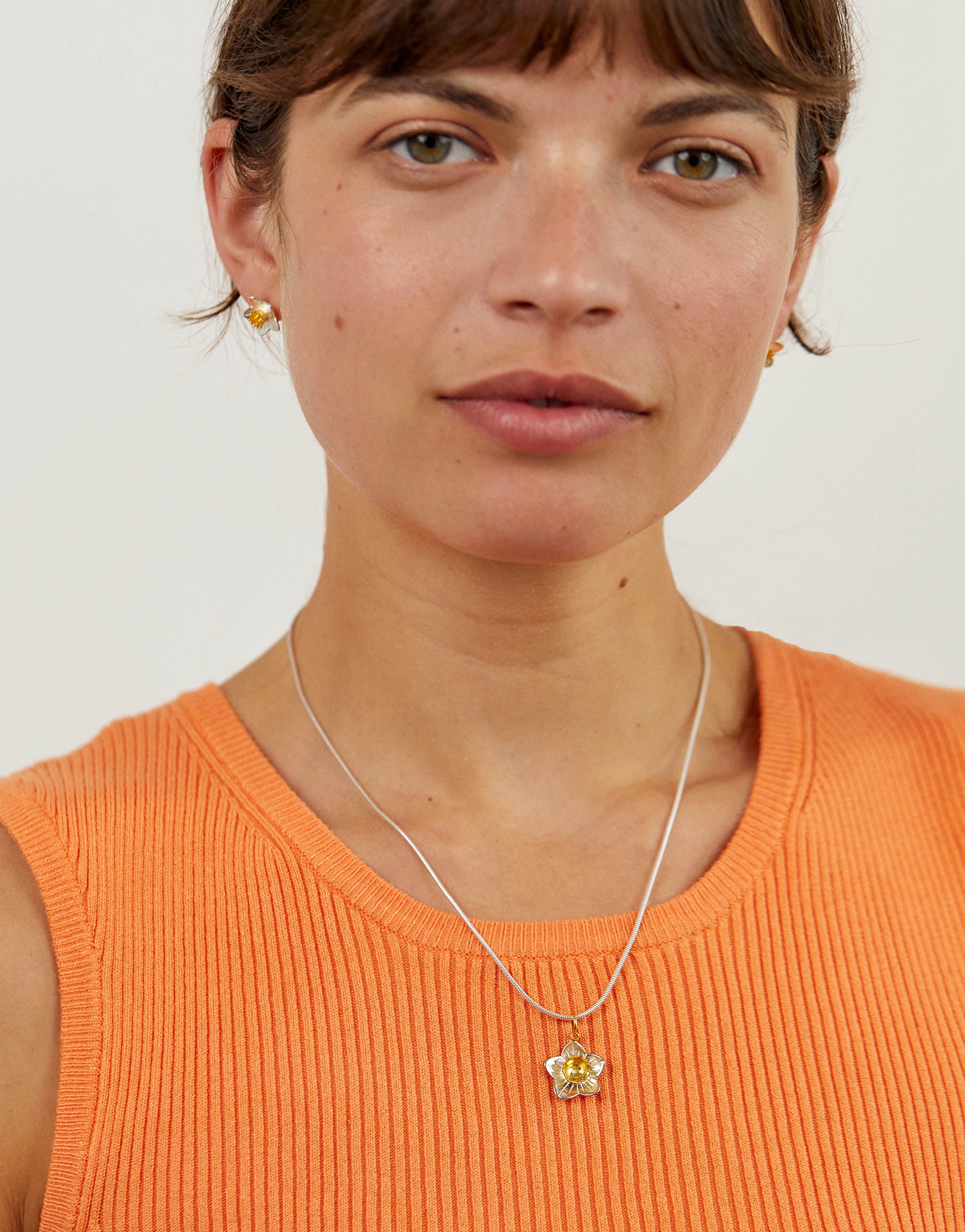 Silver daffodil necklace with a small silver daffodil pendant with 18ct gold-plated trumpet.