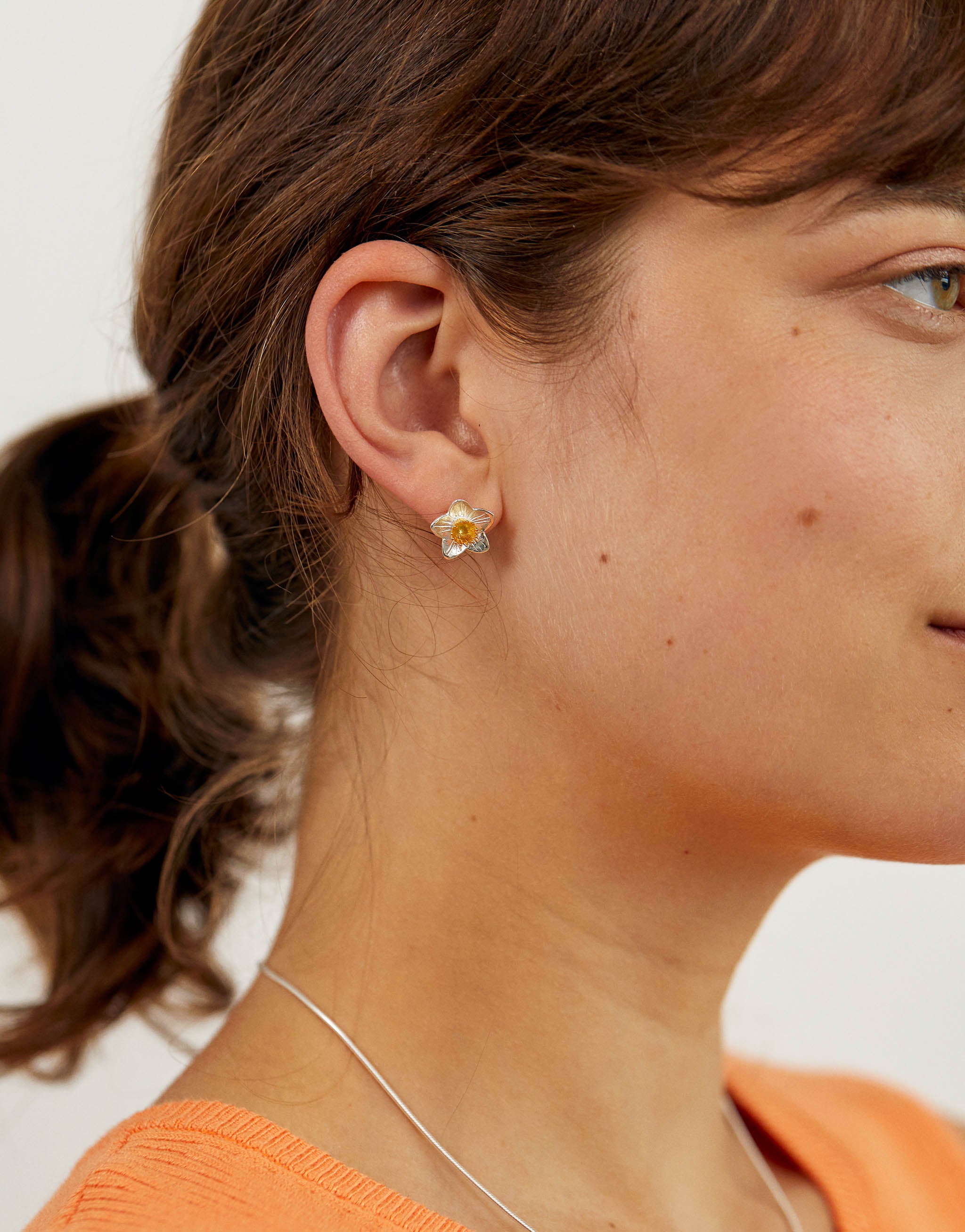 Small daffodil flower stud earrings in silver with gold accents