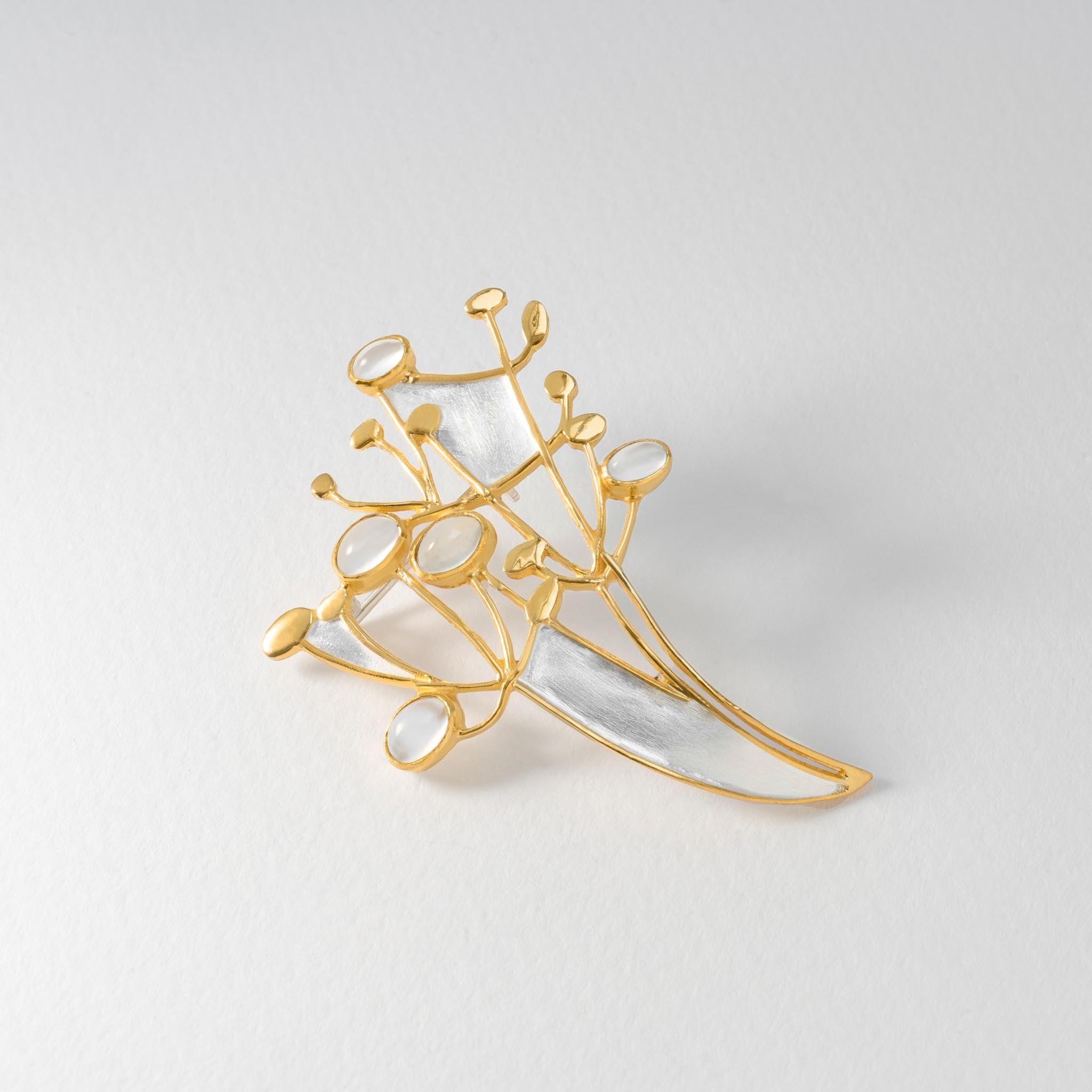 Sterling silver mistletoe brooch with gold-plated detail and shimmering moonstones.