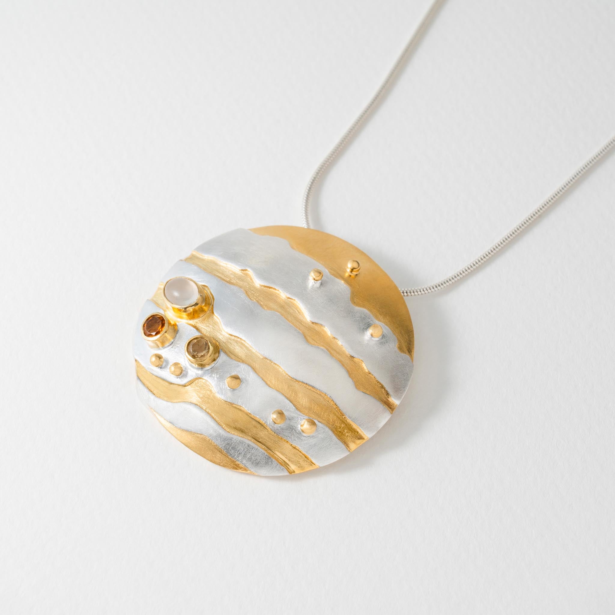 Astronomy inspired Jupiter pendant necklace in silver with gold-plated detail, citrine and moonstone.