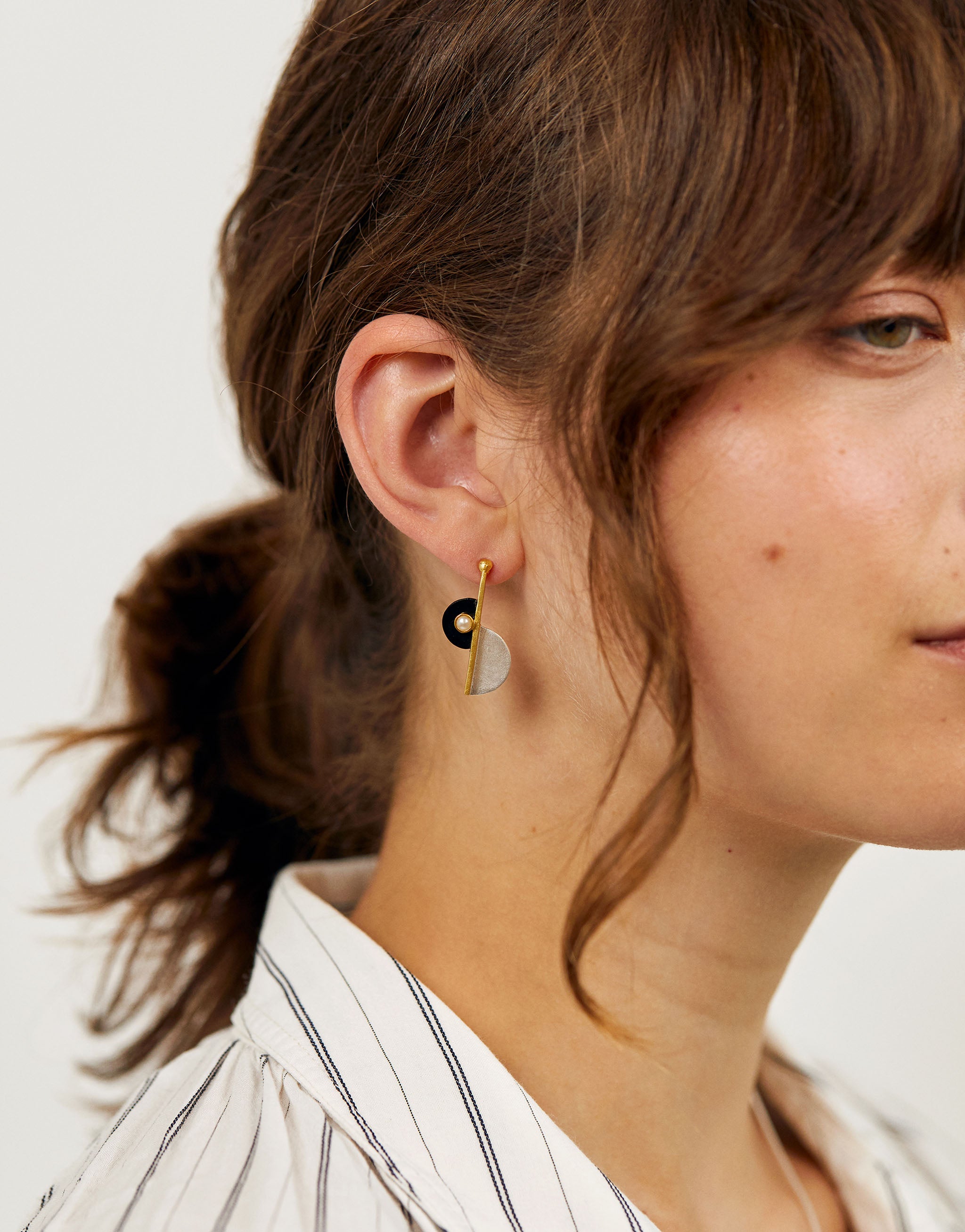 Elegant long Art Deco earrings with silver, gold accents, resin and pearl detail.