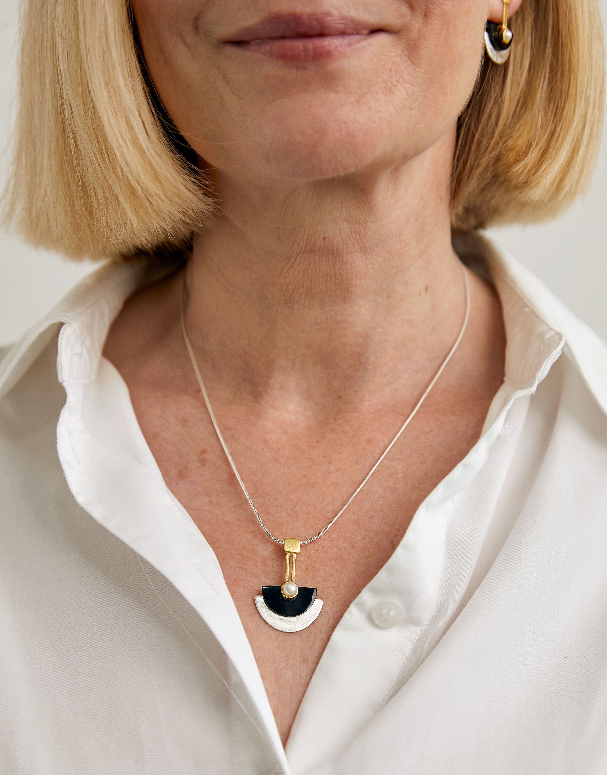 Sterling silver art deco necklace with geometric semi-circle design in black resin with pearl.