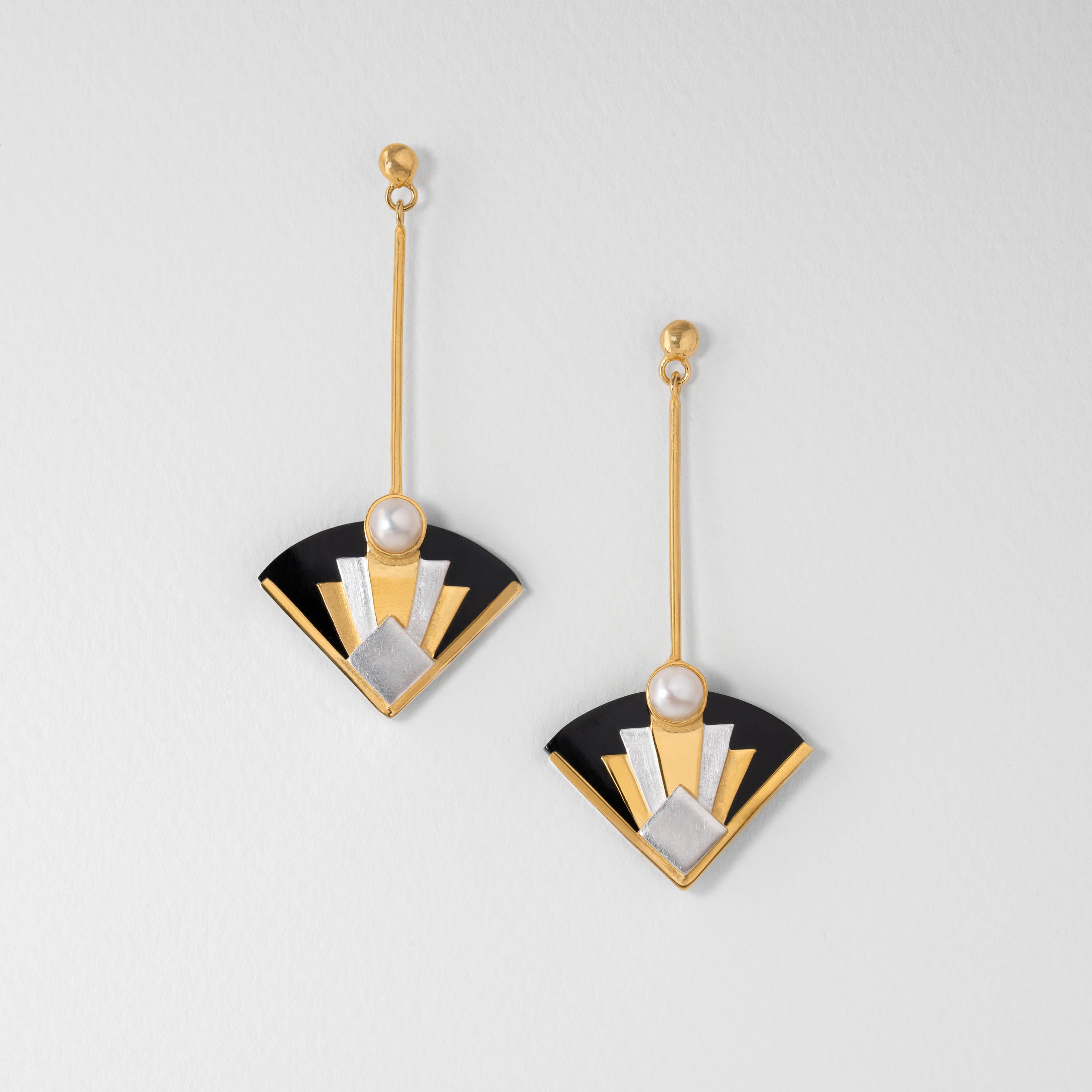 Art Deco inspired drop earrings in sterling silver with 18ct gold plate and pearl. Designed in a bold fan shape, the geometric style captures the drama and elegance of classic Art Deco jewellery.