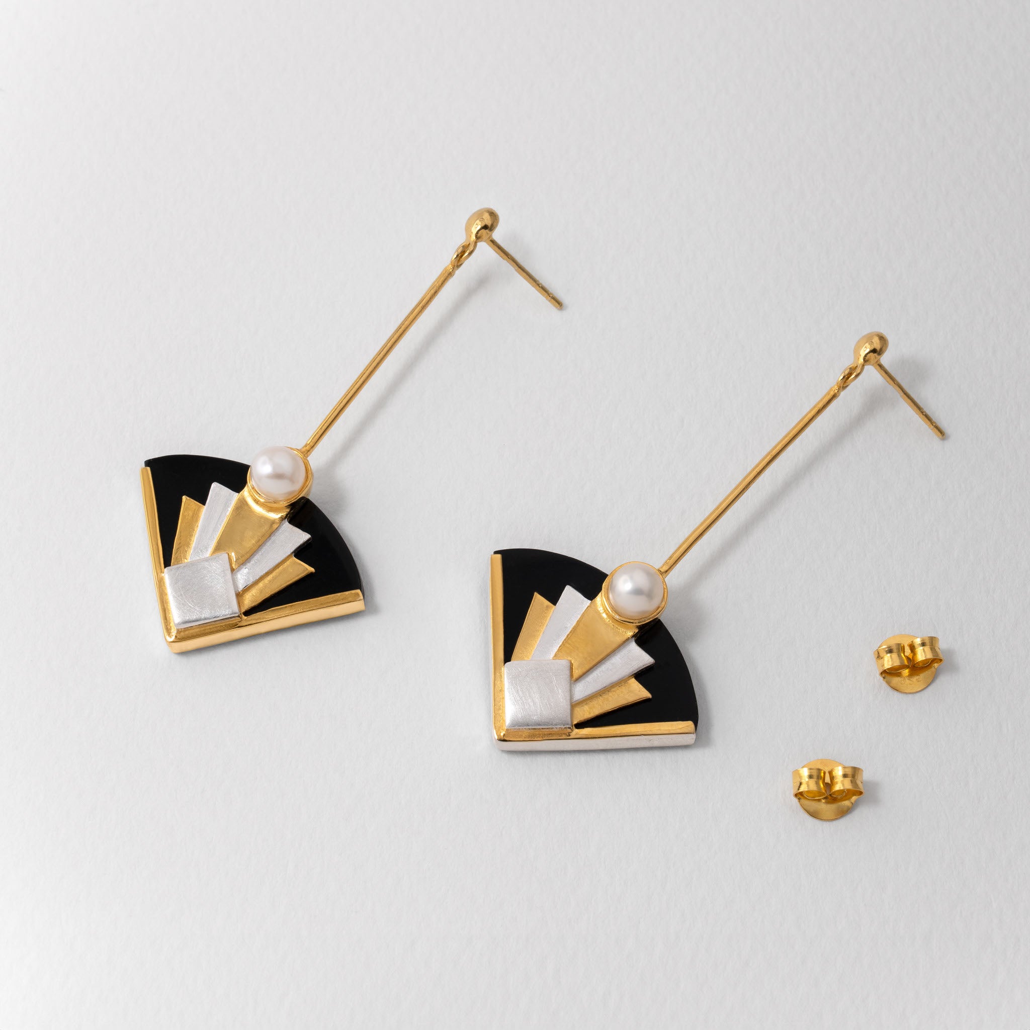 Art Deco inspired fan earrings in sterling silver with 18ct gold plate and pearl. Featuring black and silver geometric detailing, reflecting the elegance and drama of Art Deco design.