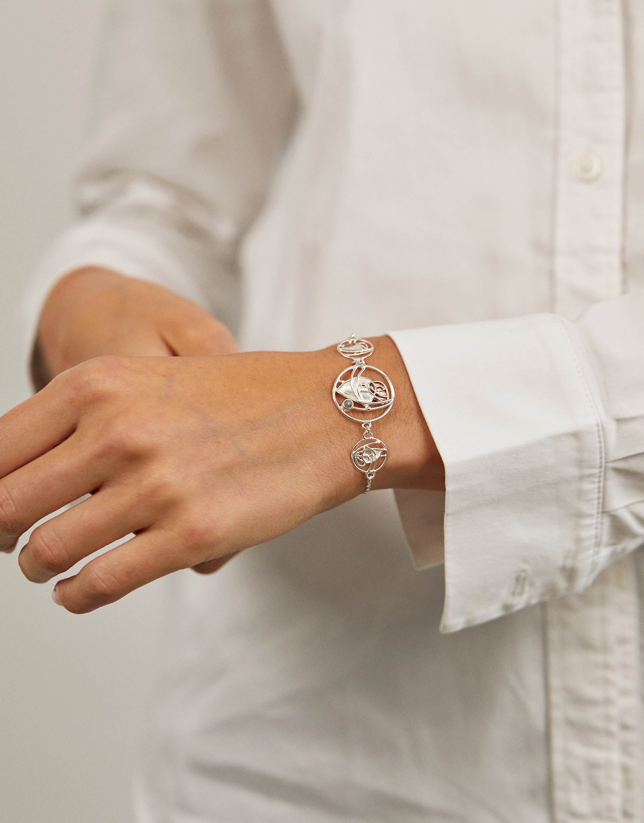 Elegant Art Nouveau bracelet with moonstone, crafted in sterling silver and copper. Inspired by Charles Rennie Mackintosh’s iconic stained-glass patterns and timeless design heritage.