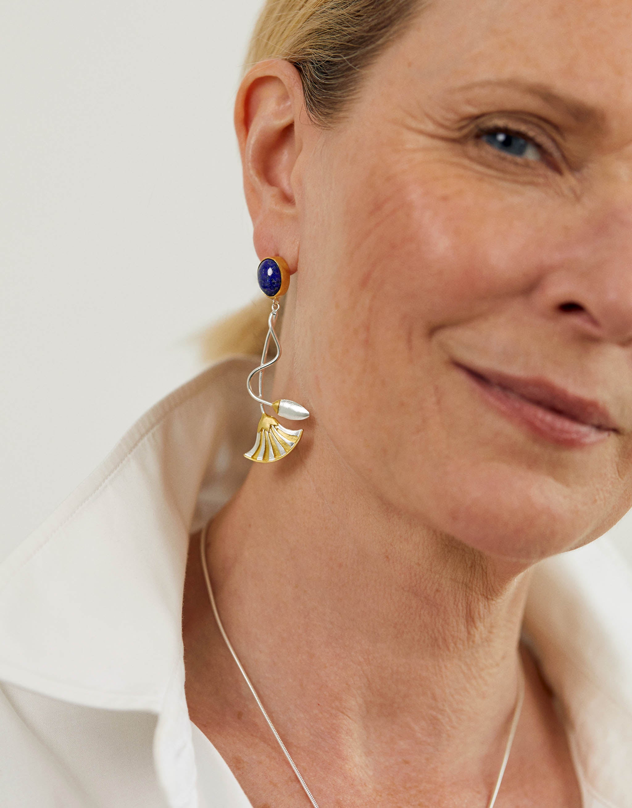 Lotus flower stud earrings in sterling silver with 18ct gold plate and lapis lazuli, inspired by Ancient Egyptian symbols of the sun, creation and rebirth.