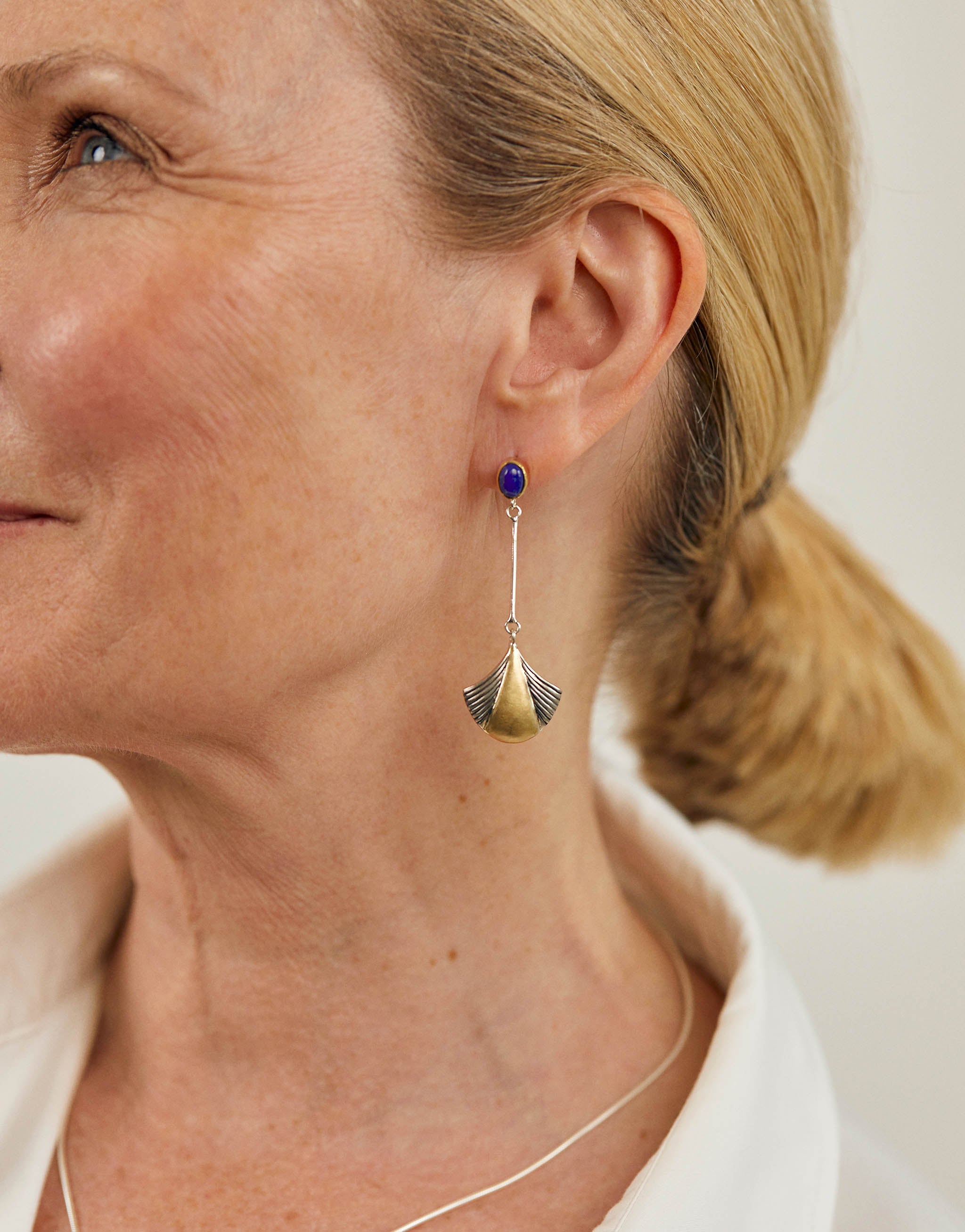 Sterling silver and 18ct gold plated drop earrings with lapis lazuli stud and fan-shaped pendant design. Elegant handcrafted jewellery.