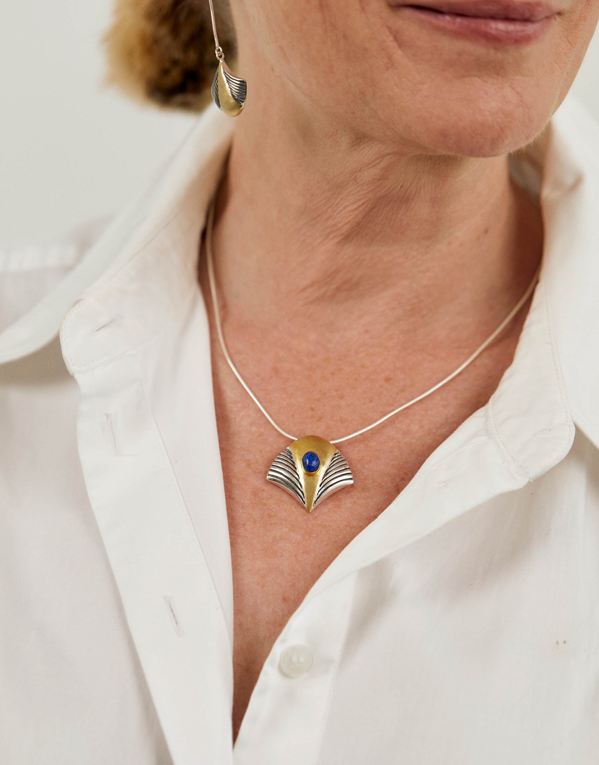 Tutankhamun inspired pendant necklace in sterling silver with 18ct gold plate and lapis lazuli detailing, reflecting the iconic golden mask of the pharaoh. Statement Egyptian jewellery on a 45cm chain with extender.