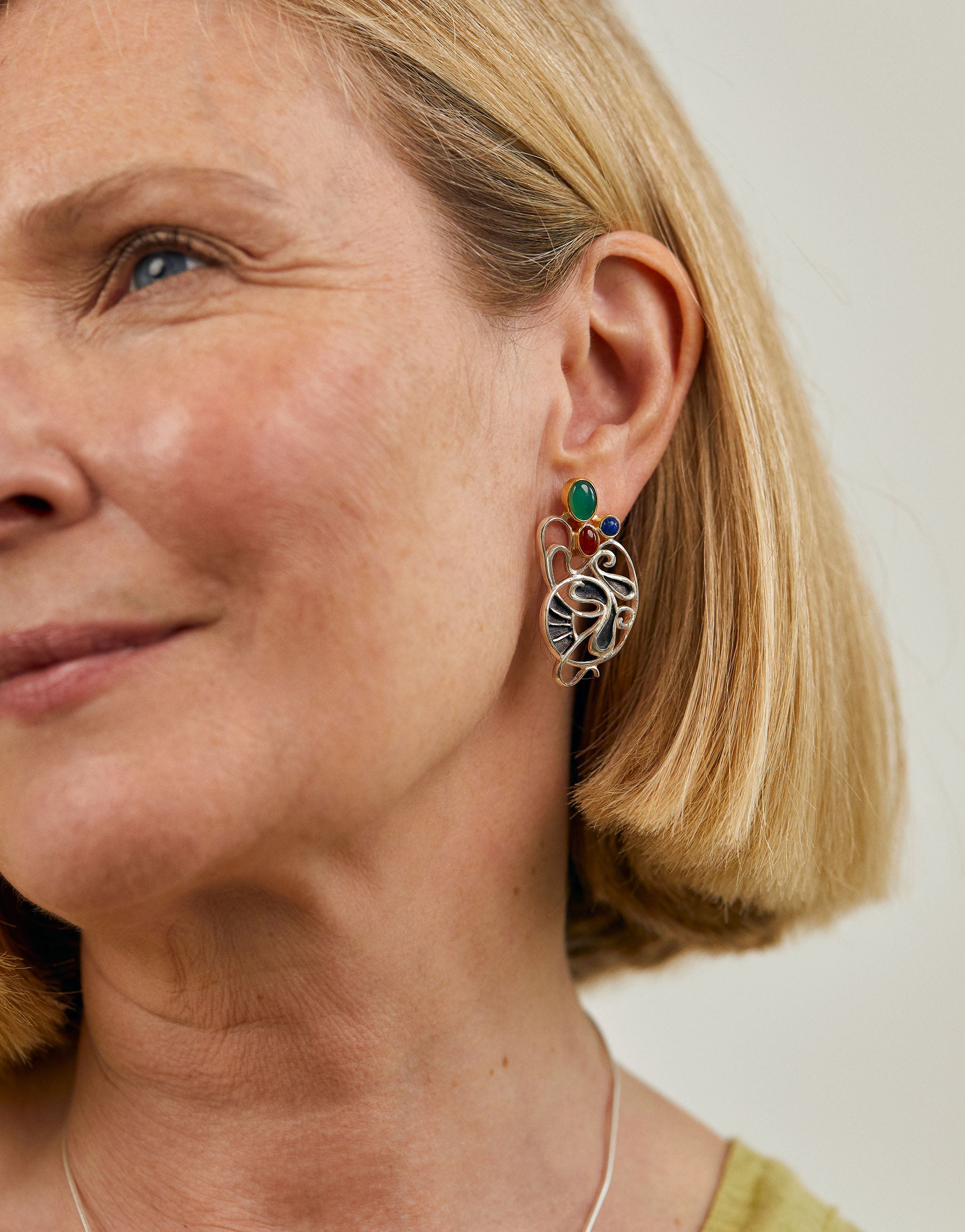 Gaudí-inspired sterling silver earrings with flowing openwork design, adorned with green agate, amber, and lapis lazuli. The organic, nature-inspired forms reflect Antoni Gaudí’s Modernist architecture, blending bold colour with surreal artistry.