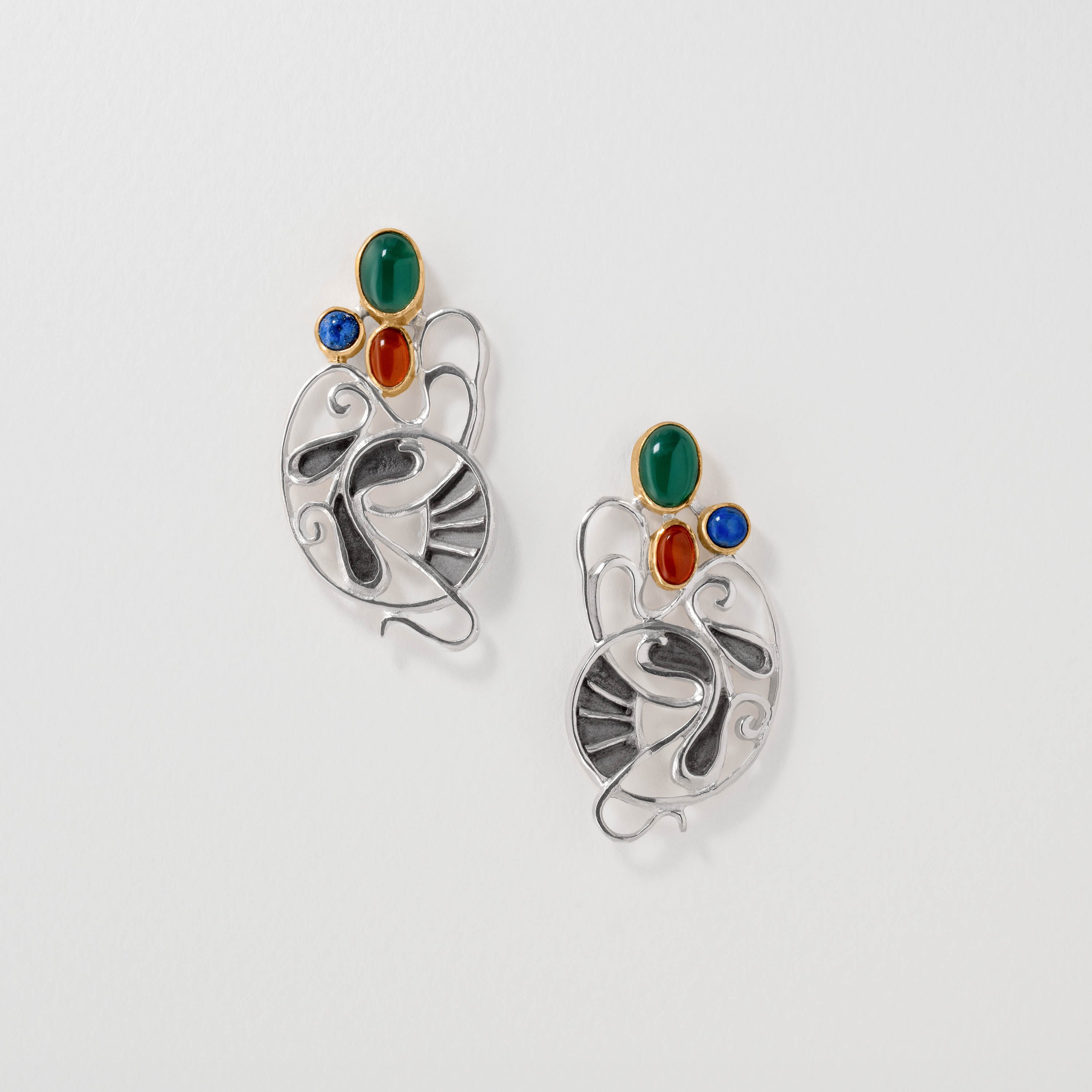 Gaudí inspired drop earrings in sterling silver with green agate, amber and lapis lazuli. Featuring flowing abstract shapes and bold colour accents, the design reflects Gaudí’s Catalan Modernist style and nature-inspired artistry.