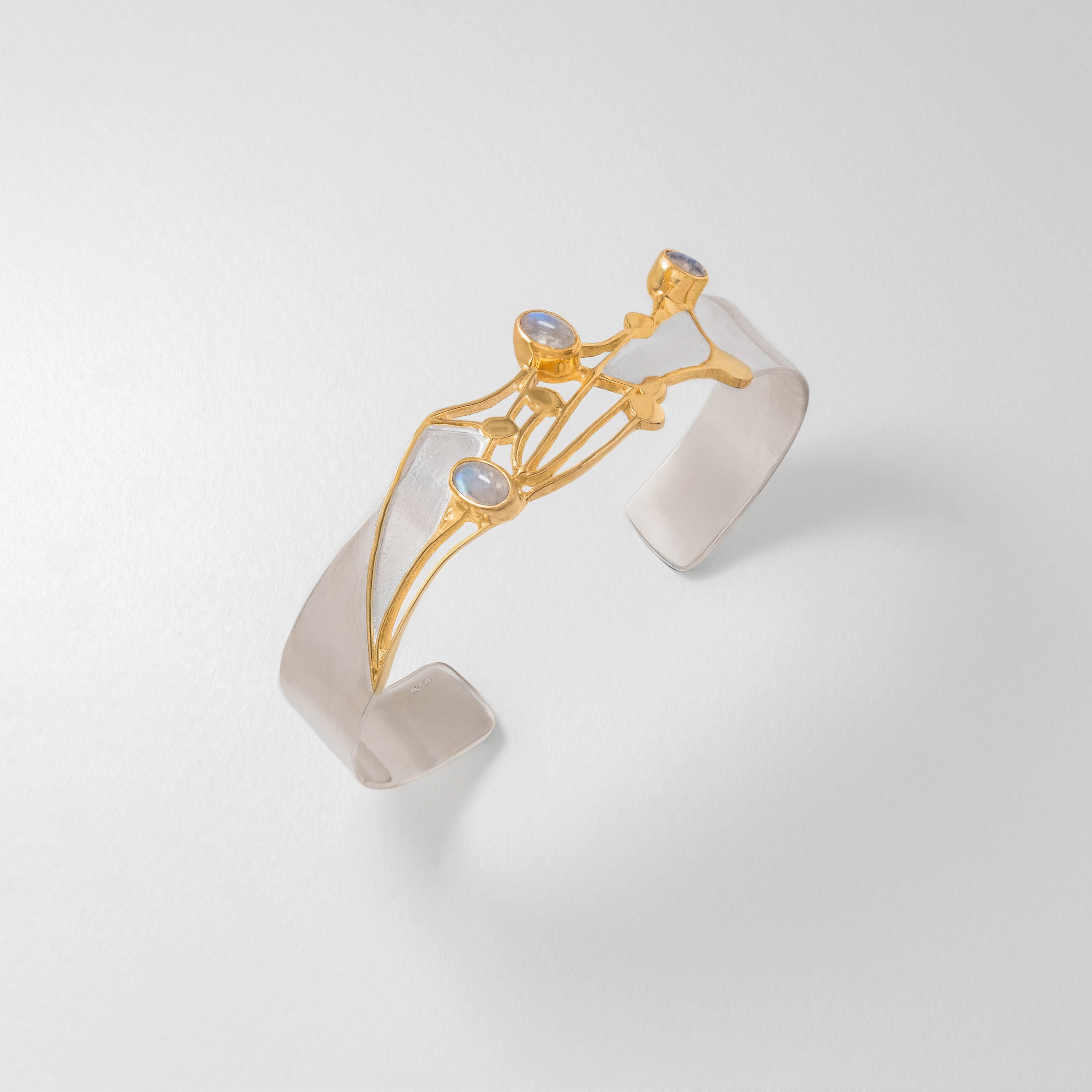 Handcrafted wildflower bangle in sterling silver with gold plating and moonstones, featuring delicate cow parsley inspired design. Nature jewellery capturing the beauty of wild blooms.