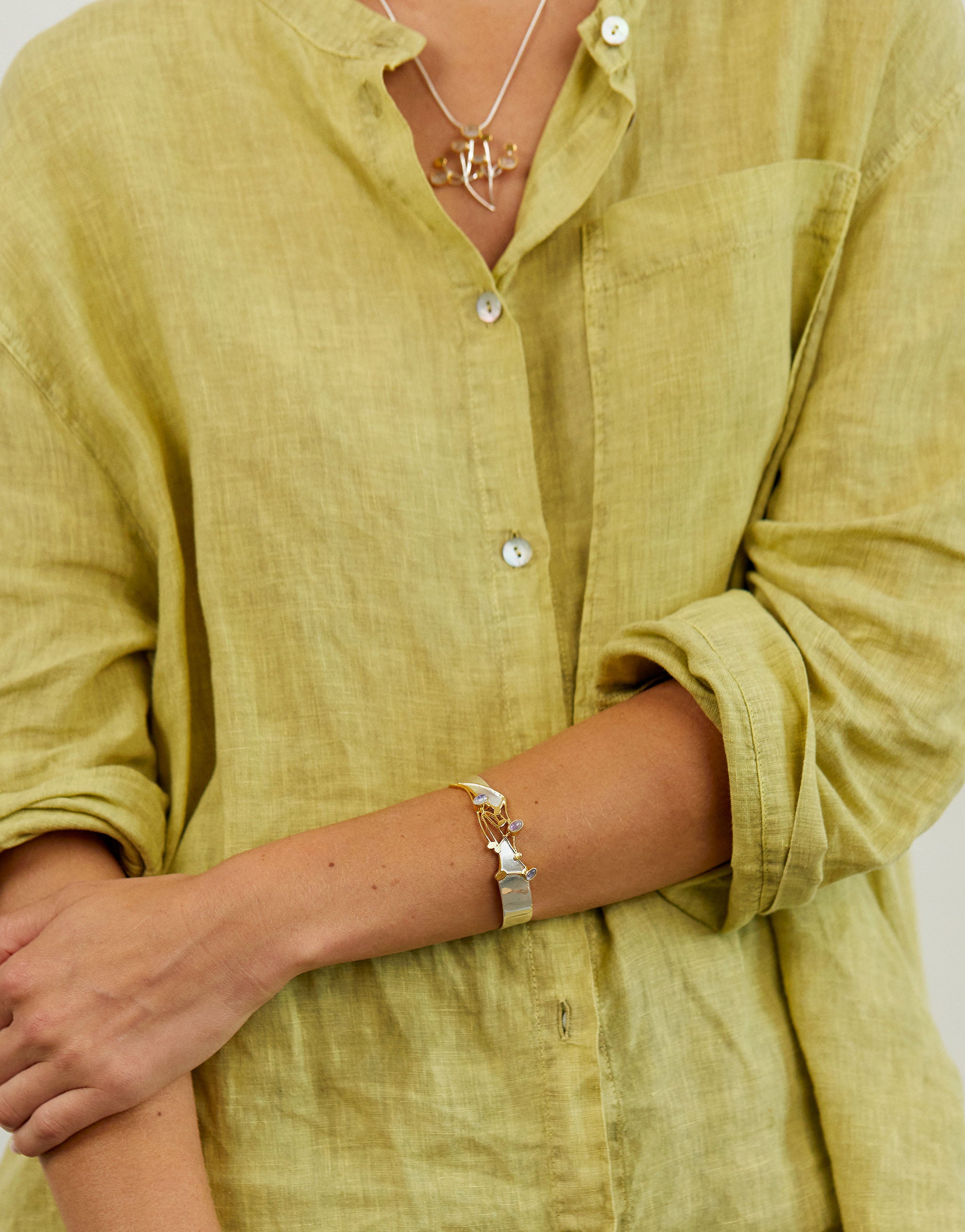 Nature-inspired wildflower bangle with silver, gold accents and luminous moonstones.