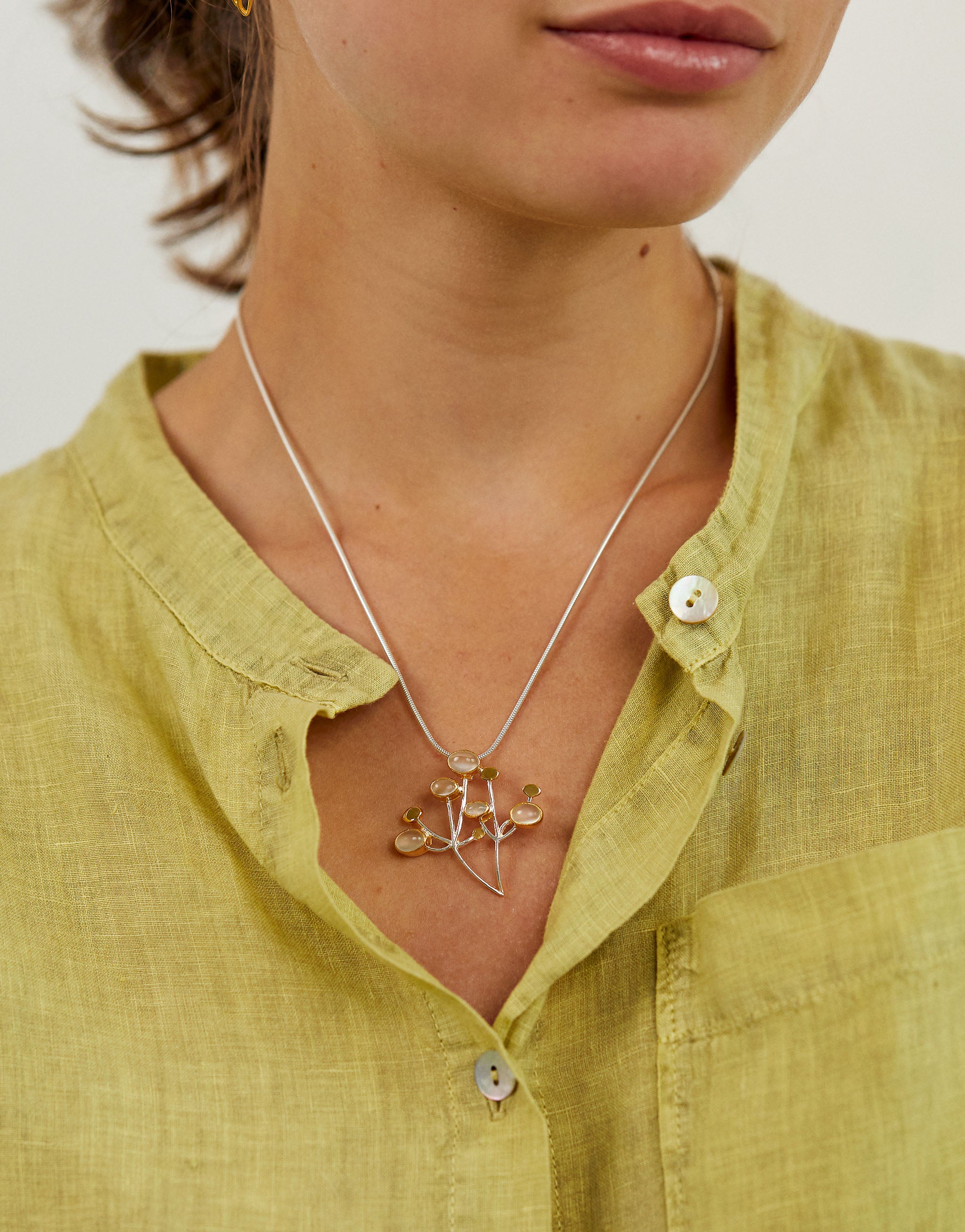 Nature-inspired wildflower necklace with silver, gold accents and moonstone gemstone.