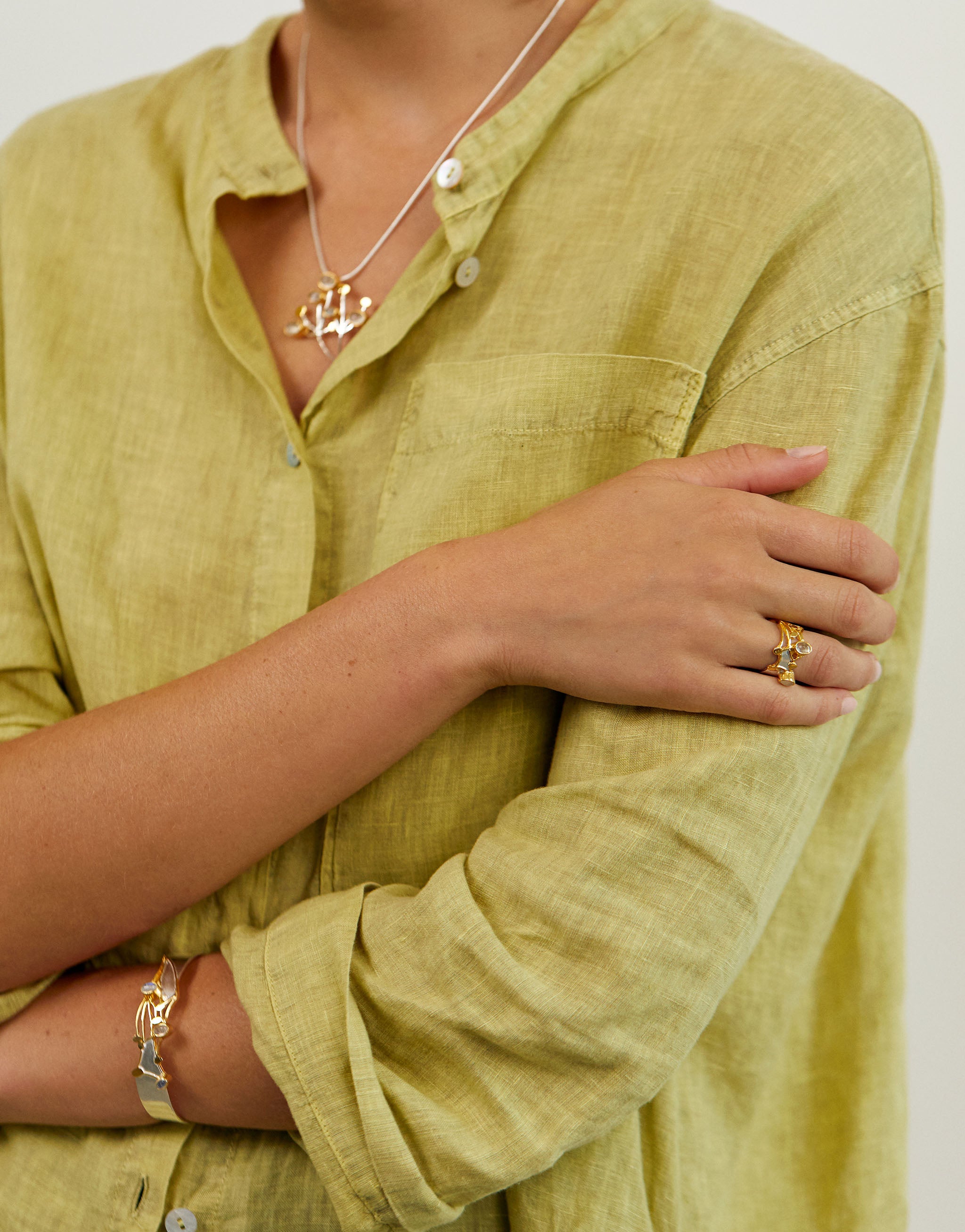 Nature-inspired wildflower ring handcrafted in silver and gold with moonstone detail.