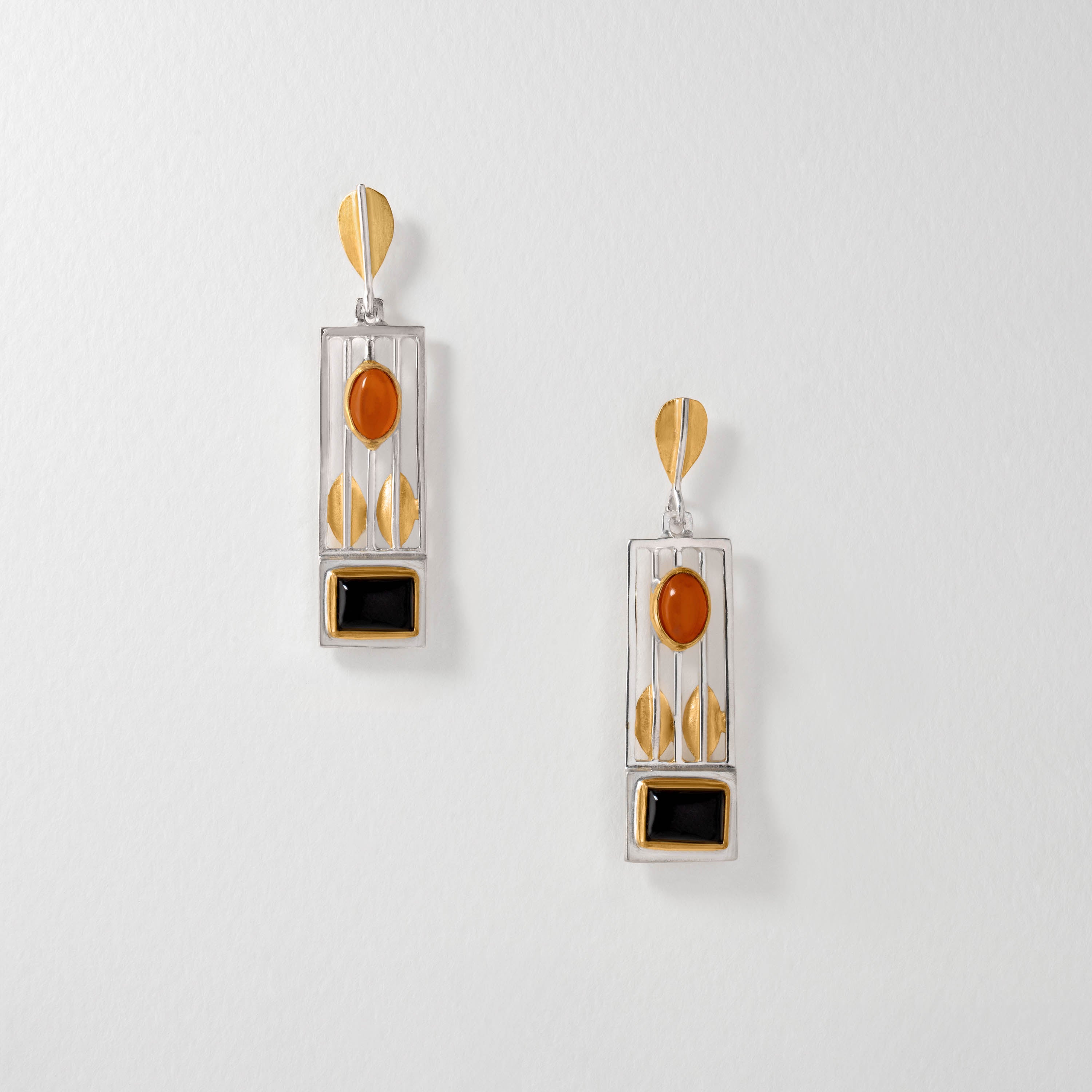 Hoffmann inspired drop earrings in sterling silver with 18ct gold plate. The geometric design features black onyx and amber gemstones, combining clean lines with bold contrasts in true Viennese modernist style.