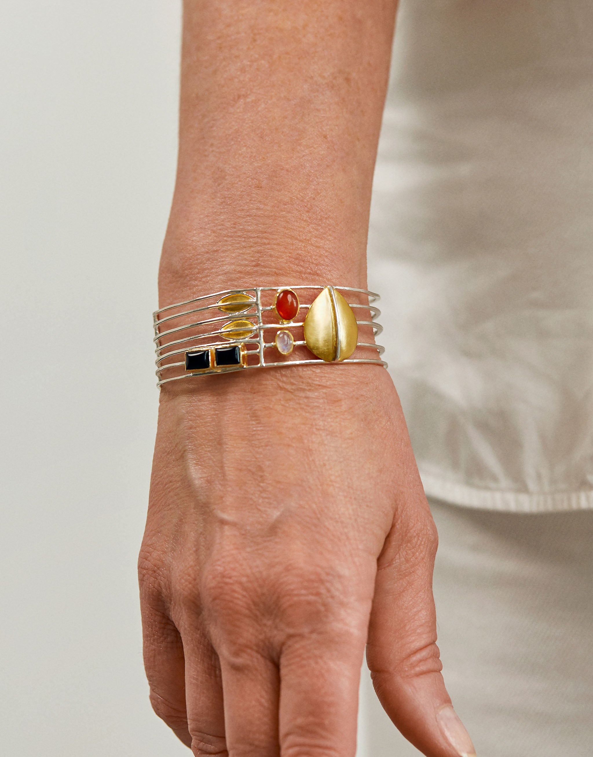 Modernist Hoffmann inspired silver bangle with geometric design, amber and onyx.