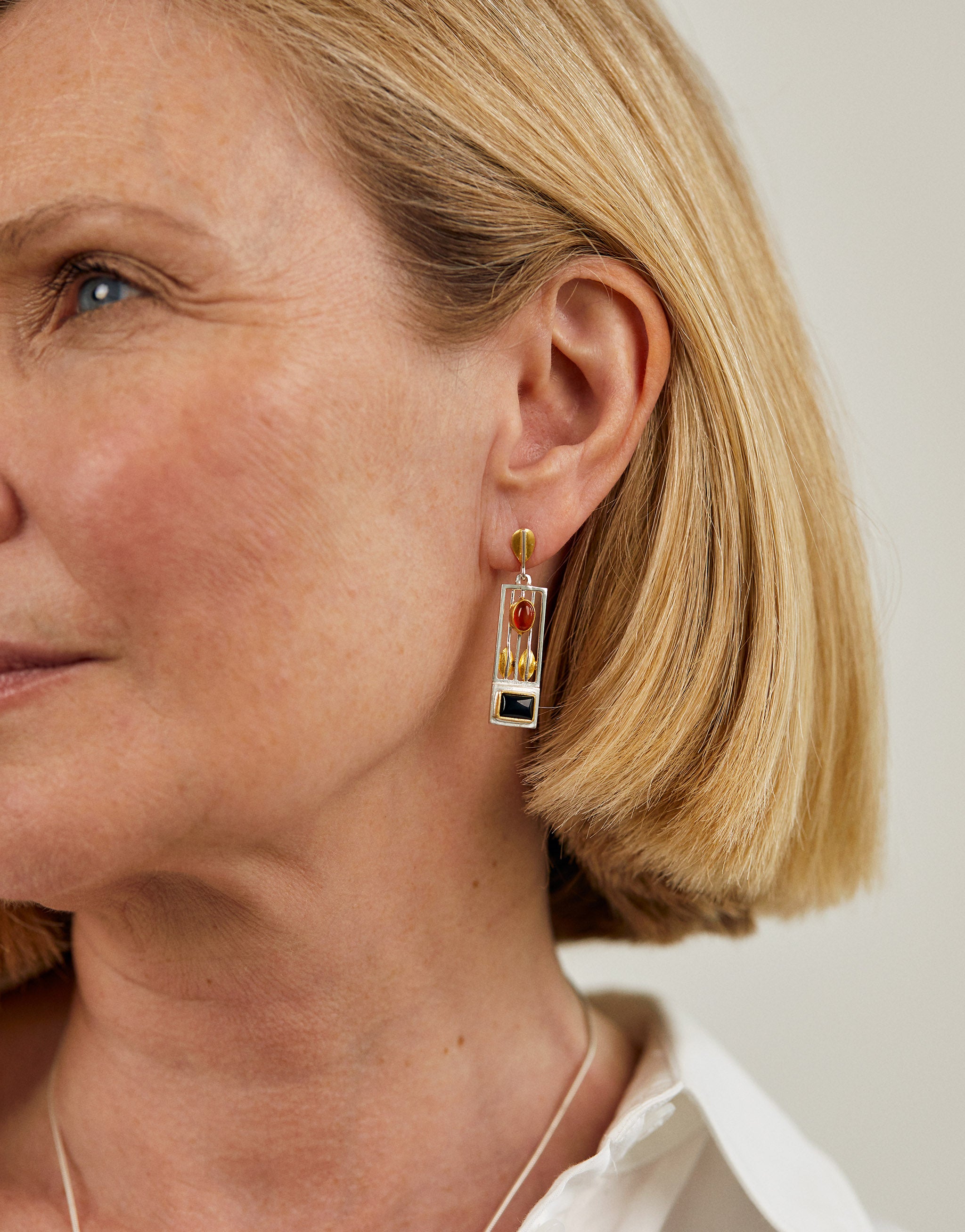 Geometric Josef Hoffmann style earrings with amber and onyx gemstones.