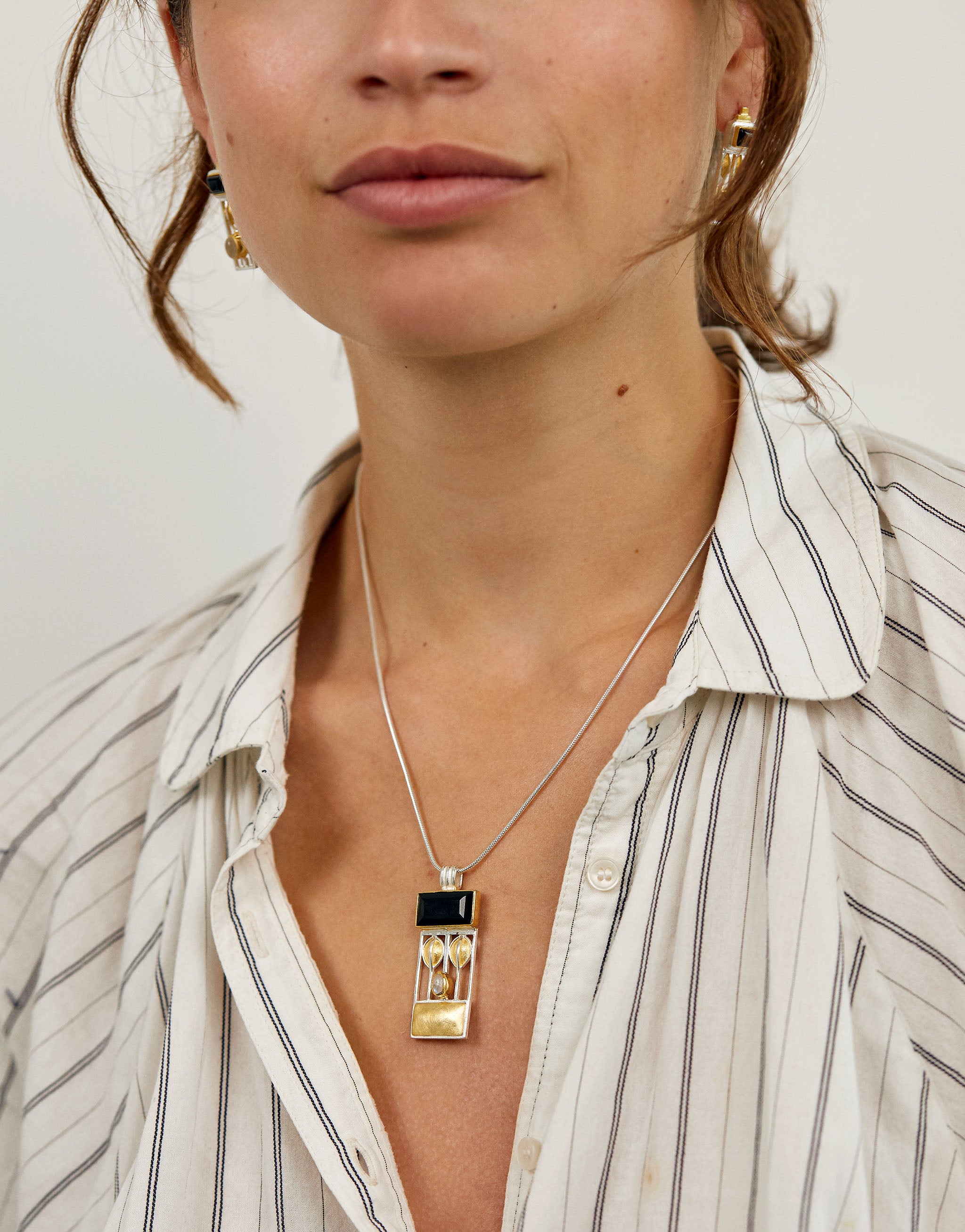 Josef Hoffmann style pendant necklace with silver, gold accents, onyx and moonstone gemstones.