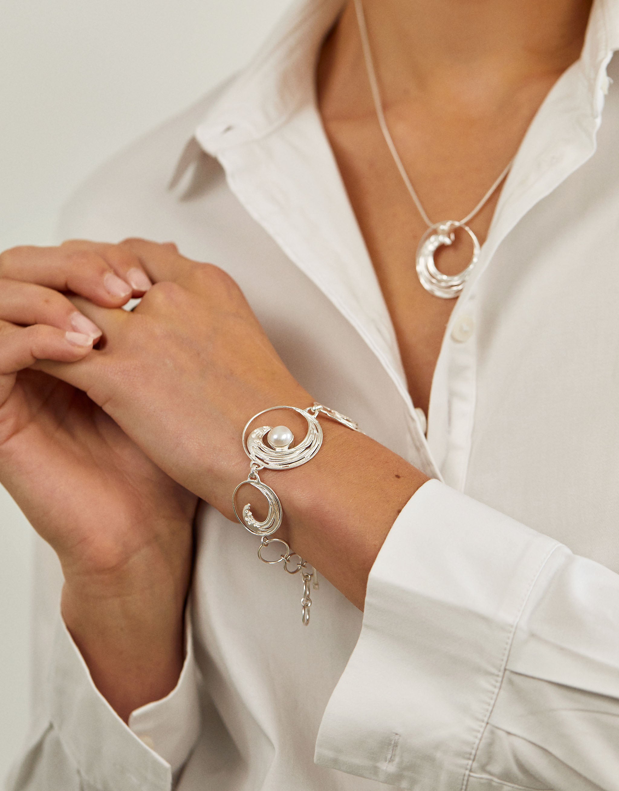 Ocean inspired Hokusai jewellery set featuring silver and pearl necklace and bracelet.