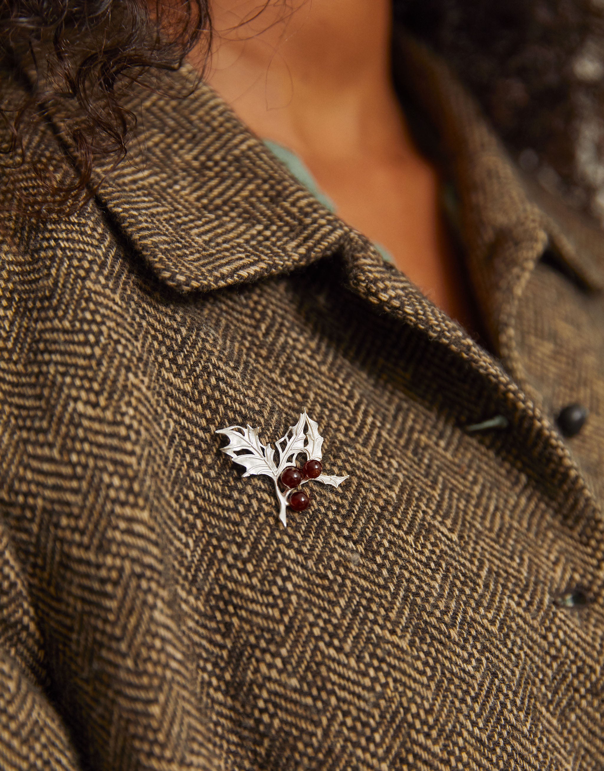 Sterling silver holly brooch with garnet berries, perfect for winter and Christmas.