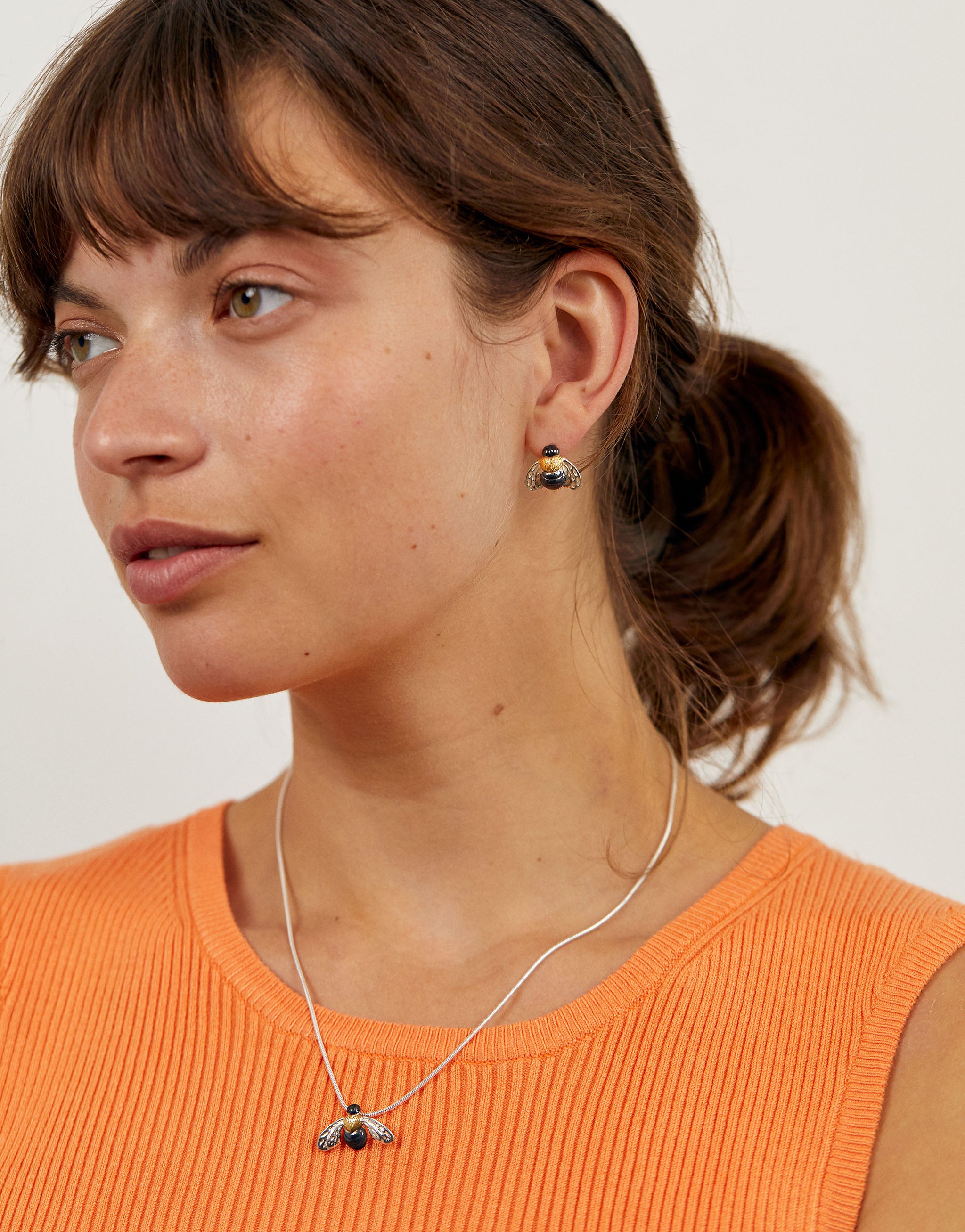 Sterling silver honeybee jewellery set featuring matching necklace and earrings, each designed with delicate silver wings, a gold-plated thorax, and oxidised body for a lifelike finish. A coordinated nature-inspired set celebrating the charm of bees.
