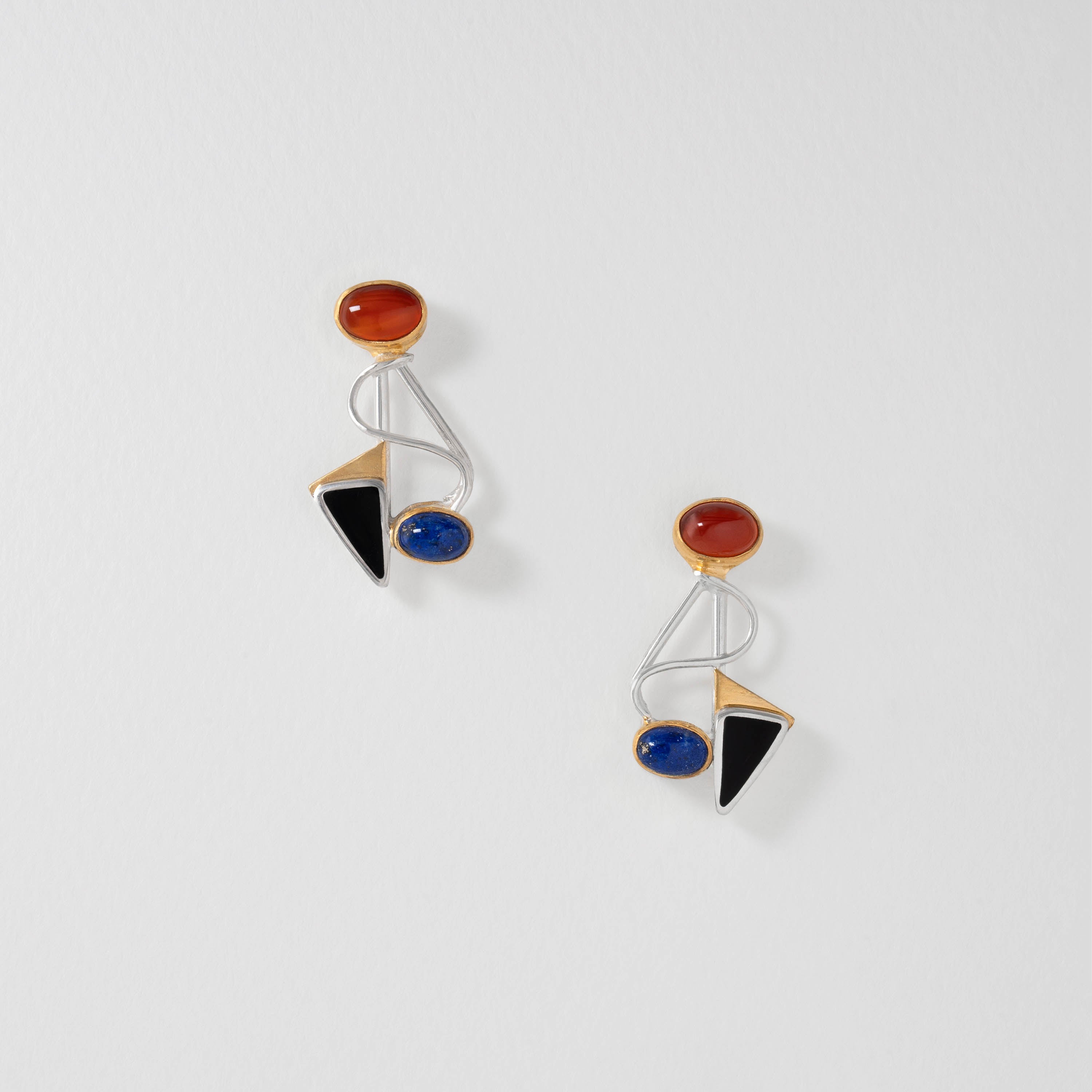 Kandinsky inspired abstract earrings in sterling silver with 18ct gold plate. Featuring curved lines and geometric shapes set with red carnelian, blue lapis lazuli and black onyx, the design reflects the artist’s bold use of colour and form.