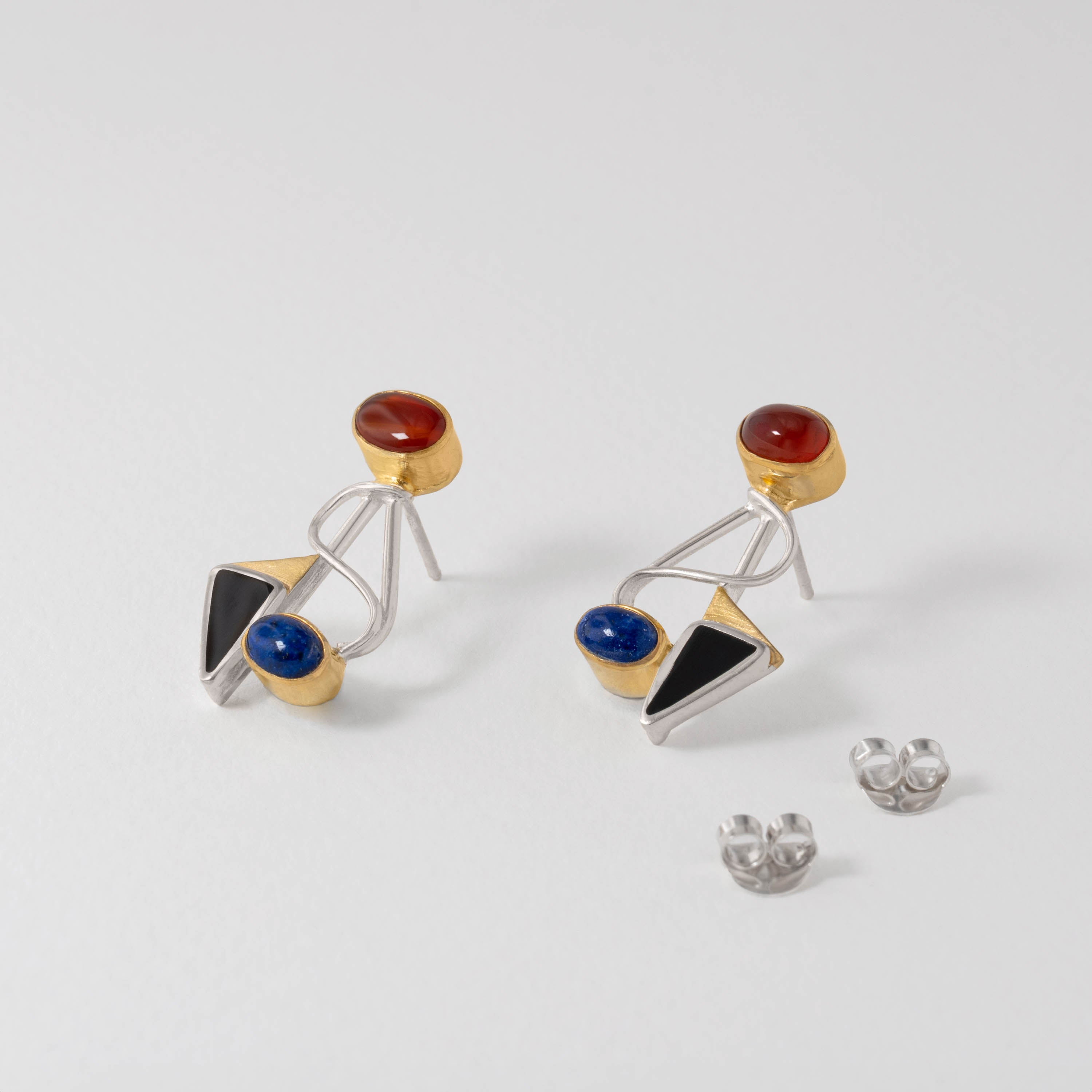 Abstract Kandinsky earrings crafted in sterling silver with gold-plated detail. The modernist design combines carnelian, lapis lazuli and onyx gemstones in bold geometric forms, echoing Kandinsky’s avant-garde artistry.
