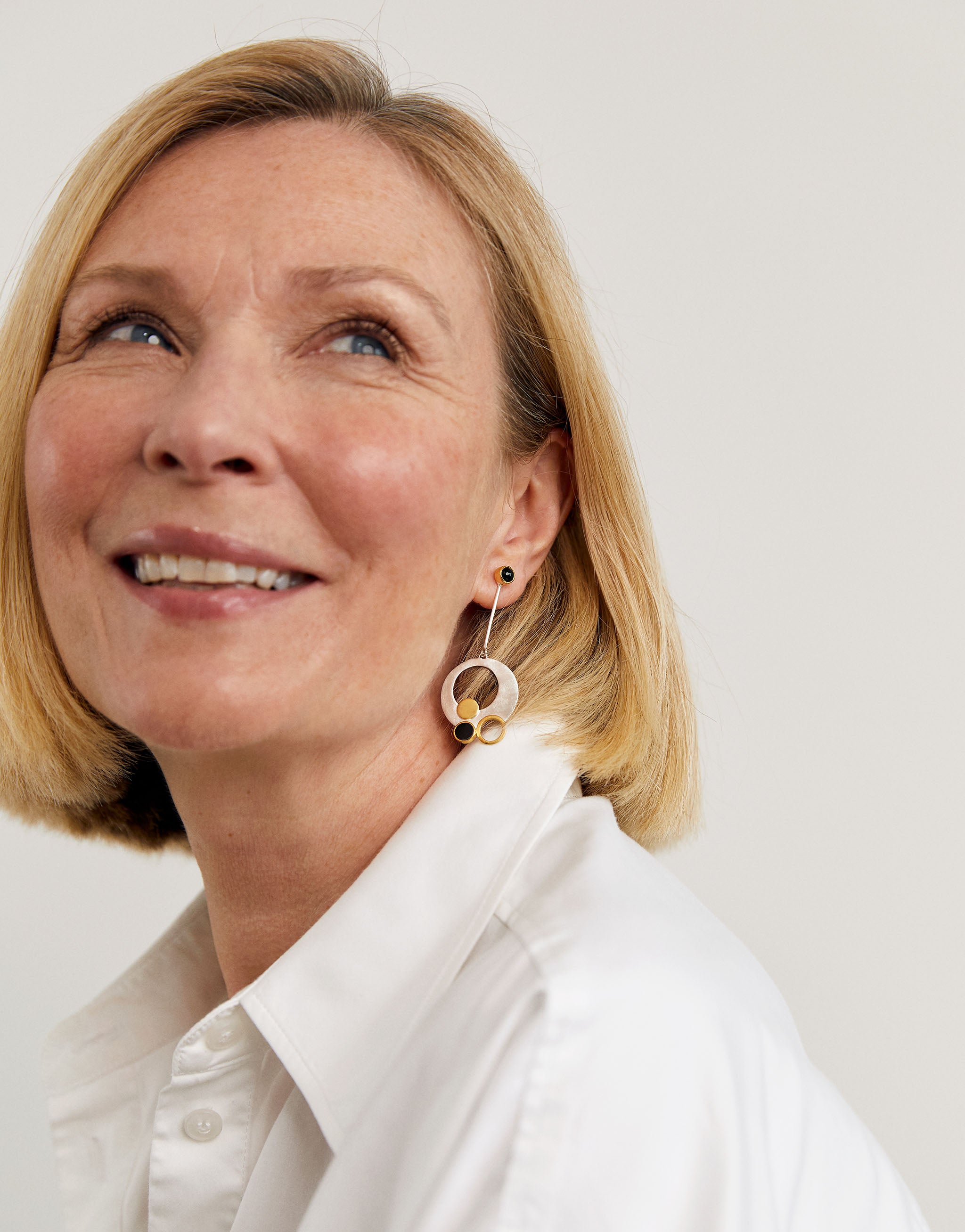 Art-inspired Klimt earrings in silver and gold with black onyx detail.