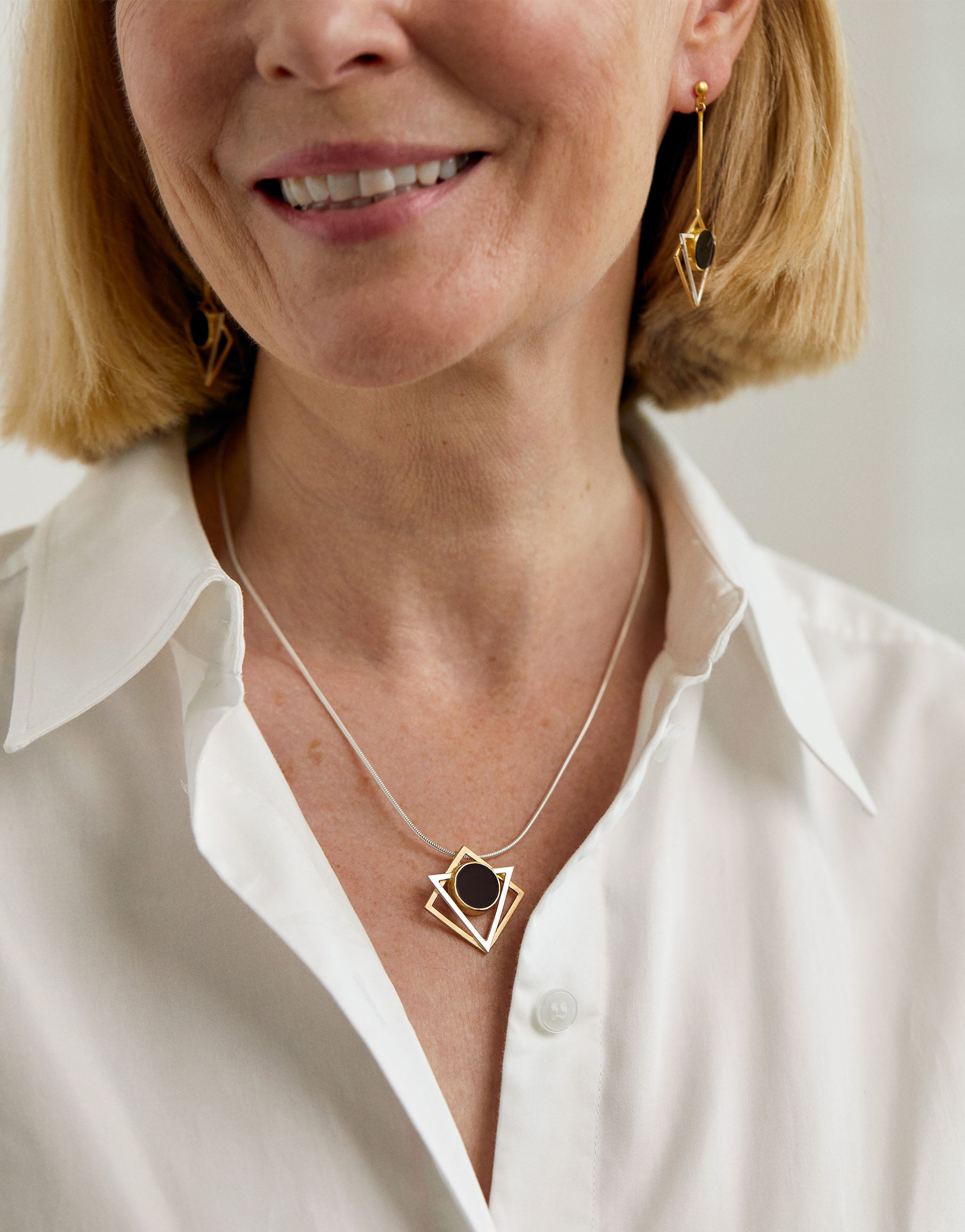 Klimt inspired geometric pendant necklace in sterling silver with 18ct gold plate and black resin.