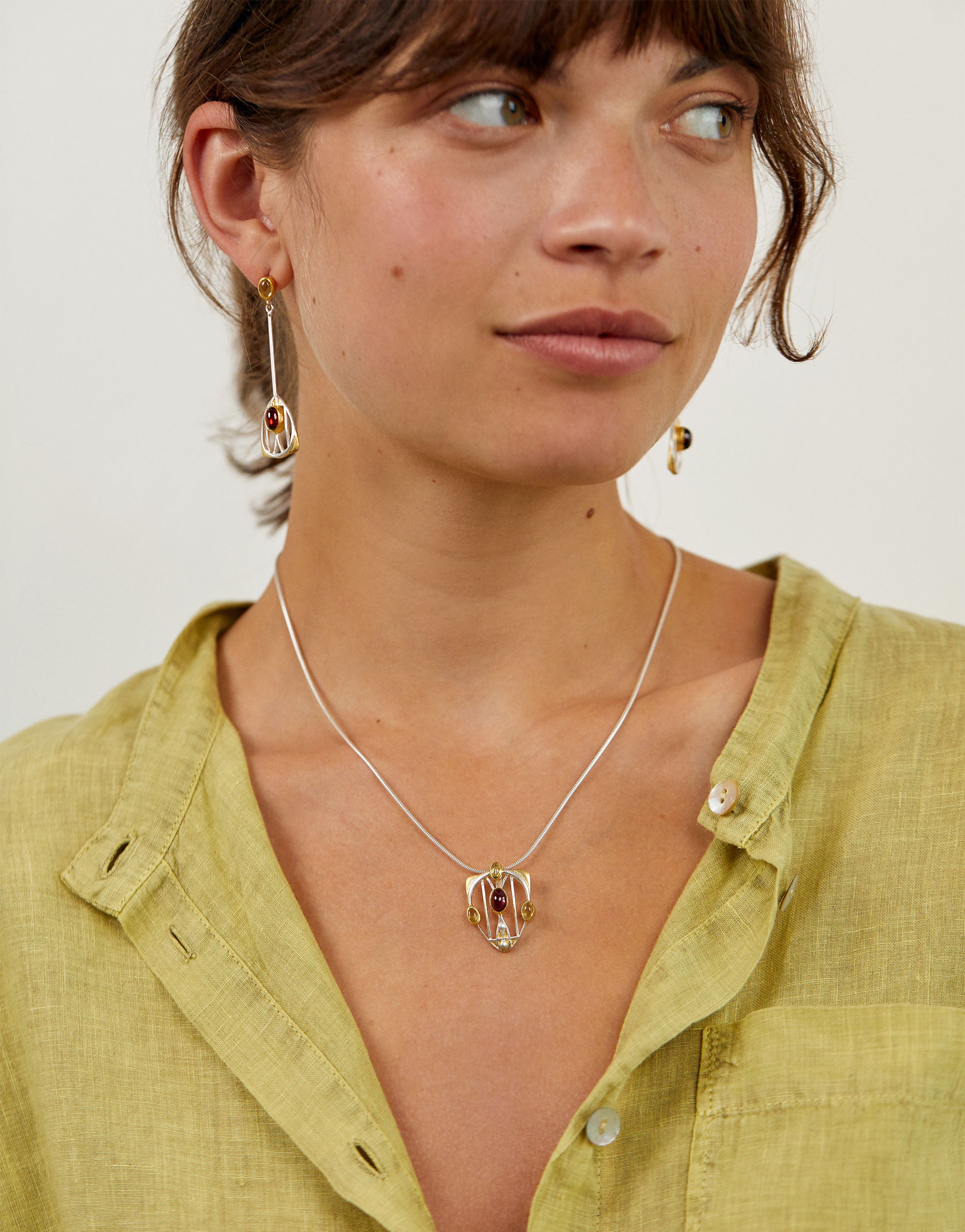 Sterling silver and gold-plated Macdonald Gesso jewellery collection featuring garnet and peridot.