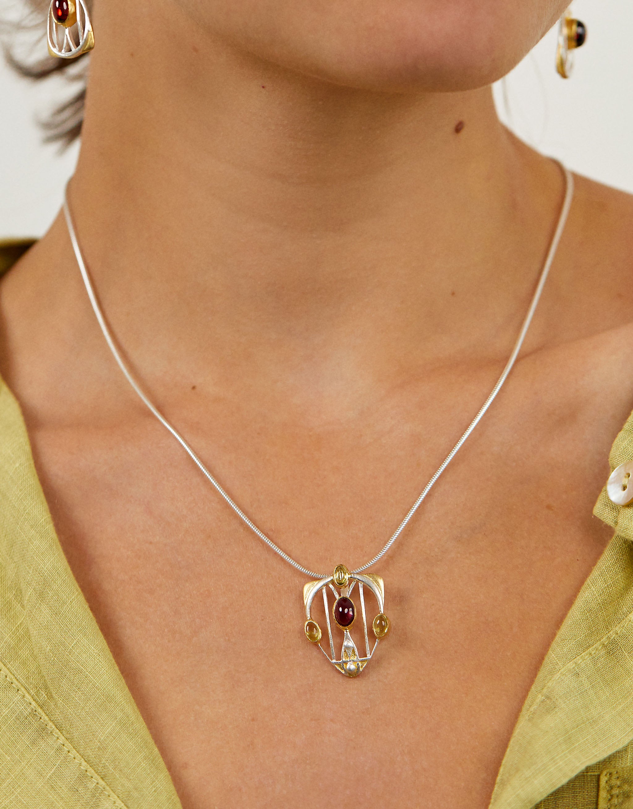 Sterling silver and gold-plated Macdonald Gesso pendant necklace featuring garnet and peridot.