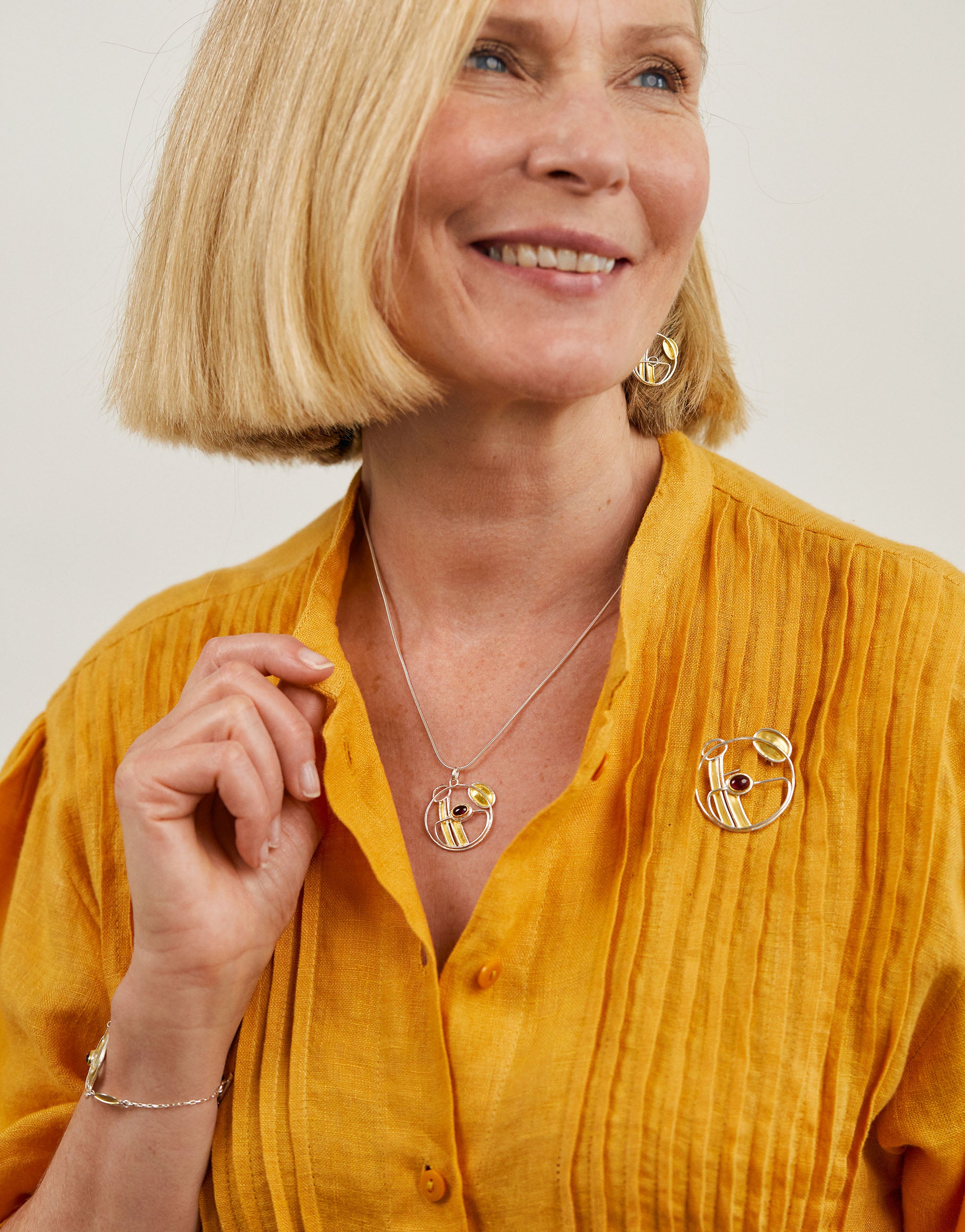 Art Nouveau inspired Mackintosh set with silver necklace, earrings and brooch featuring garnet gemstones.