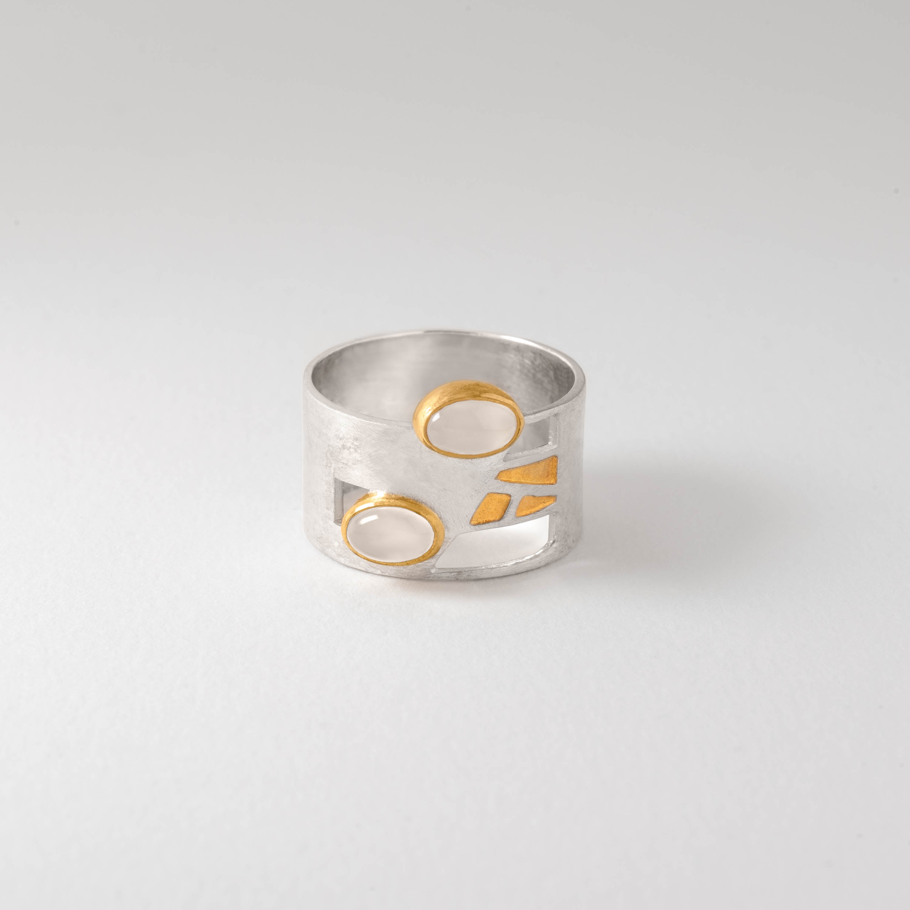 Mackintosh Willow Tea Rooms inspired ring with sterling silver and 18ct gold plate, featuring a luminous moonstone centre. Geometric Art Nouveau design blending heritage and modern elegance.