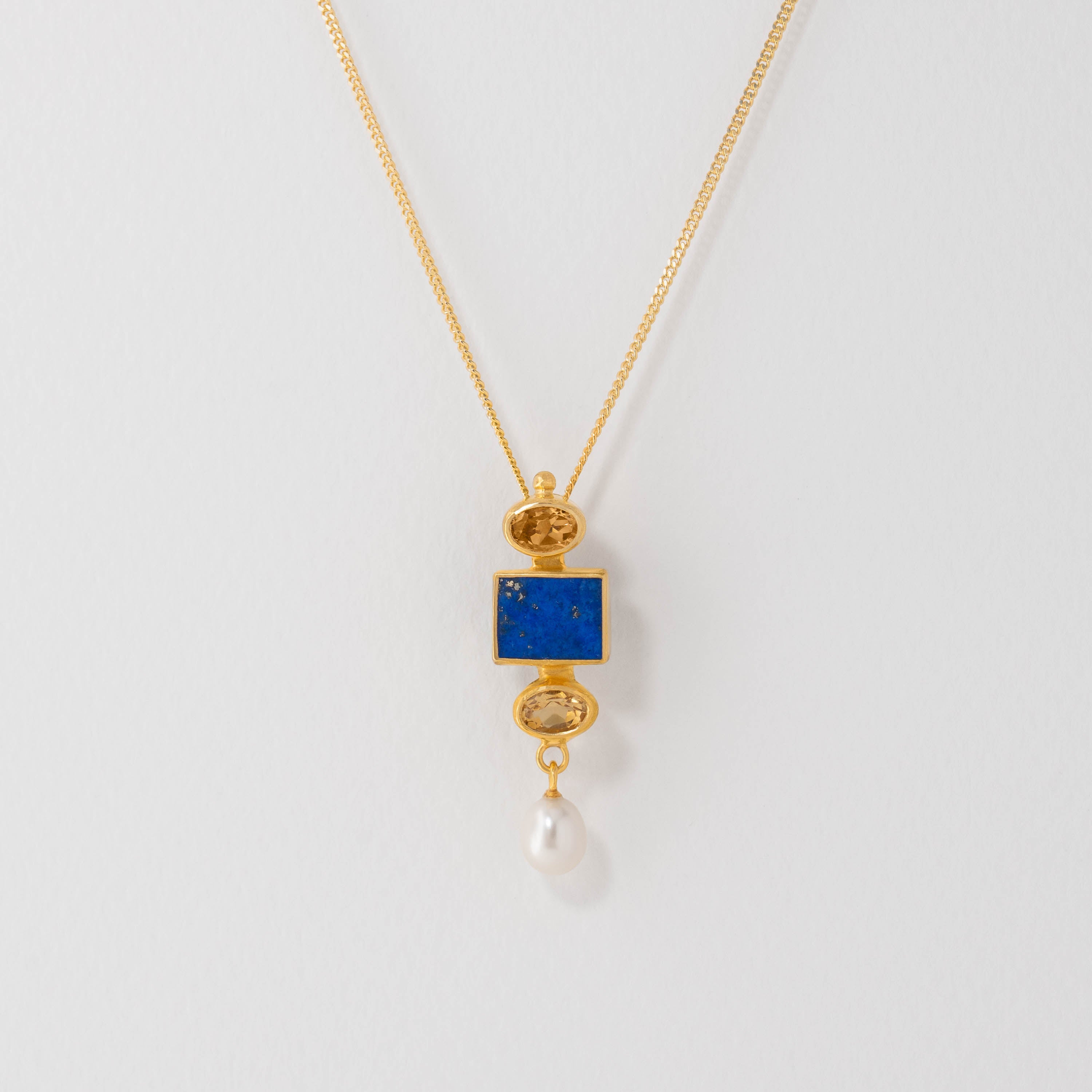 Vermeer inspired pendant necklace in 18ct gold plate with lapis lazuli, citrine and freshwater pearl. The harmonious colours echo the artistry of Vermeer’s paintings, blending classic elegance with contemporary design.