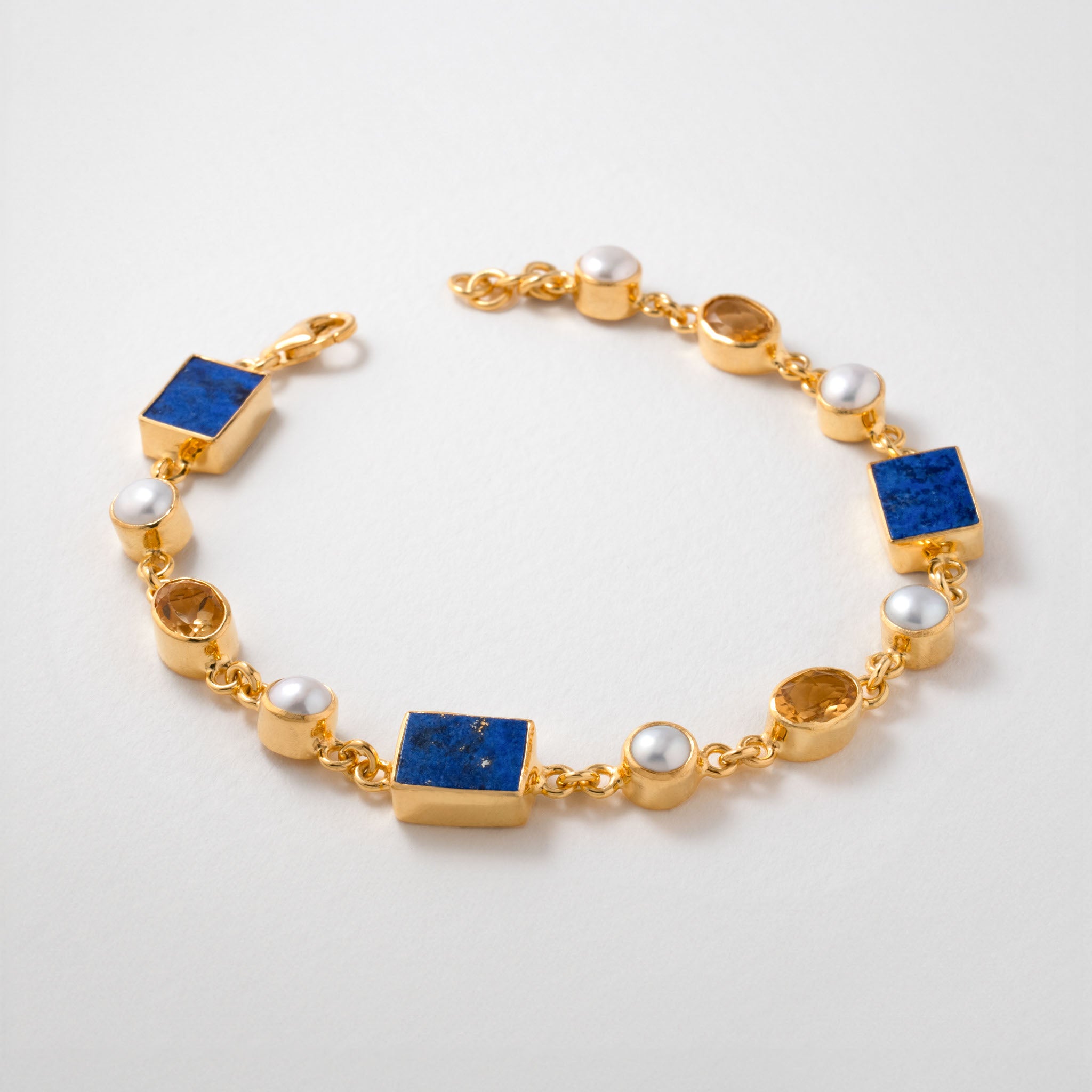 Vermeer inspired bracelet in 18ct gold plated silver, featuring lapis lazuli, citrine, and freshwater pearls. The design echoes the harmonious colour palette of Vermeer’s paintings, blending timeless artistry with modern elegance.
