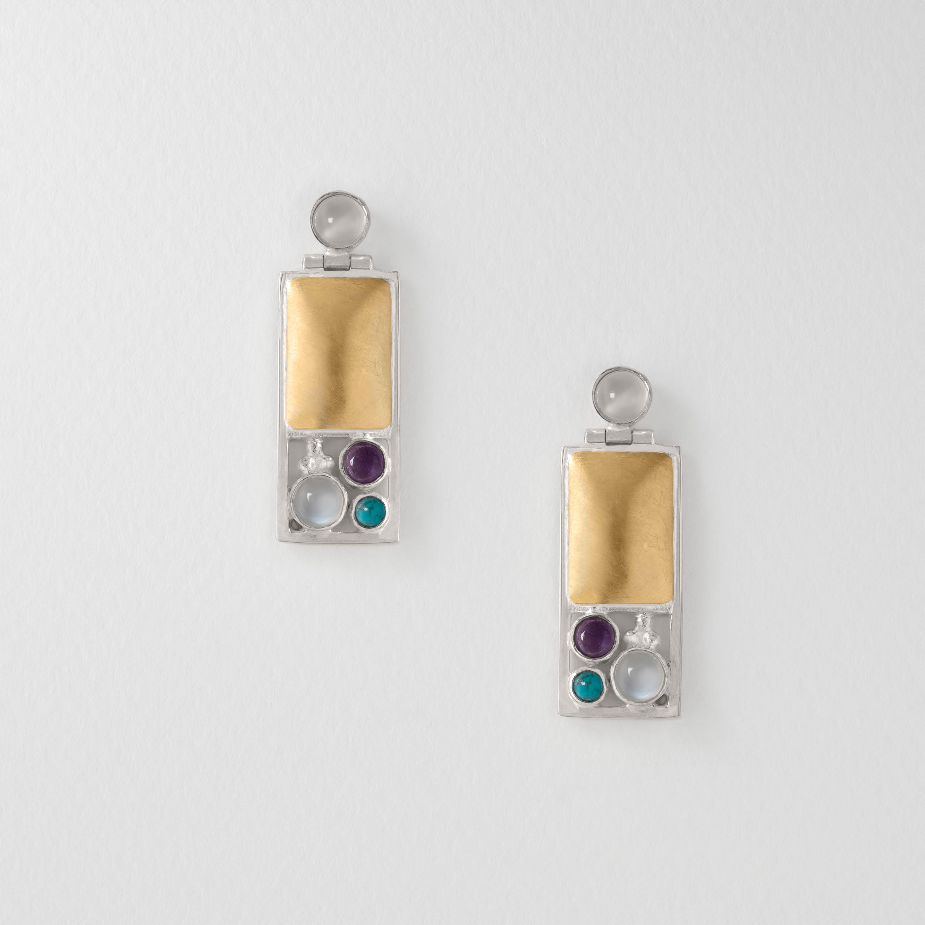 Hoffmann Vienna inspired drop earrings in sterling silver with 18ct gold plate. Featuring sleek rectangular forms with moonstone, iolite and turquoise accents, the design reflects Hoffmann’s fusion of art, architecture and elegant modernism.