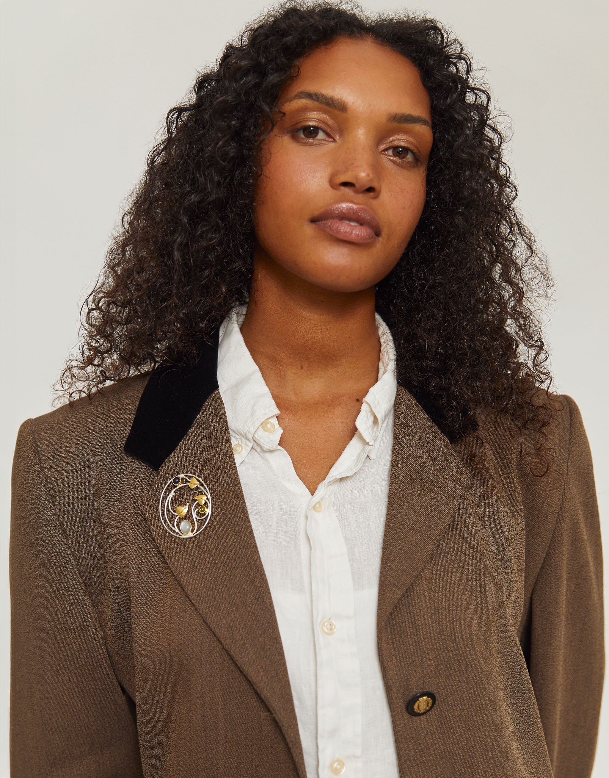 Art Nouveau inspired Willowwood brooch with silver, gold accents, iolite and peridot gemstones.