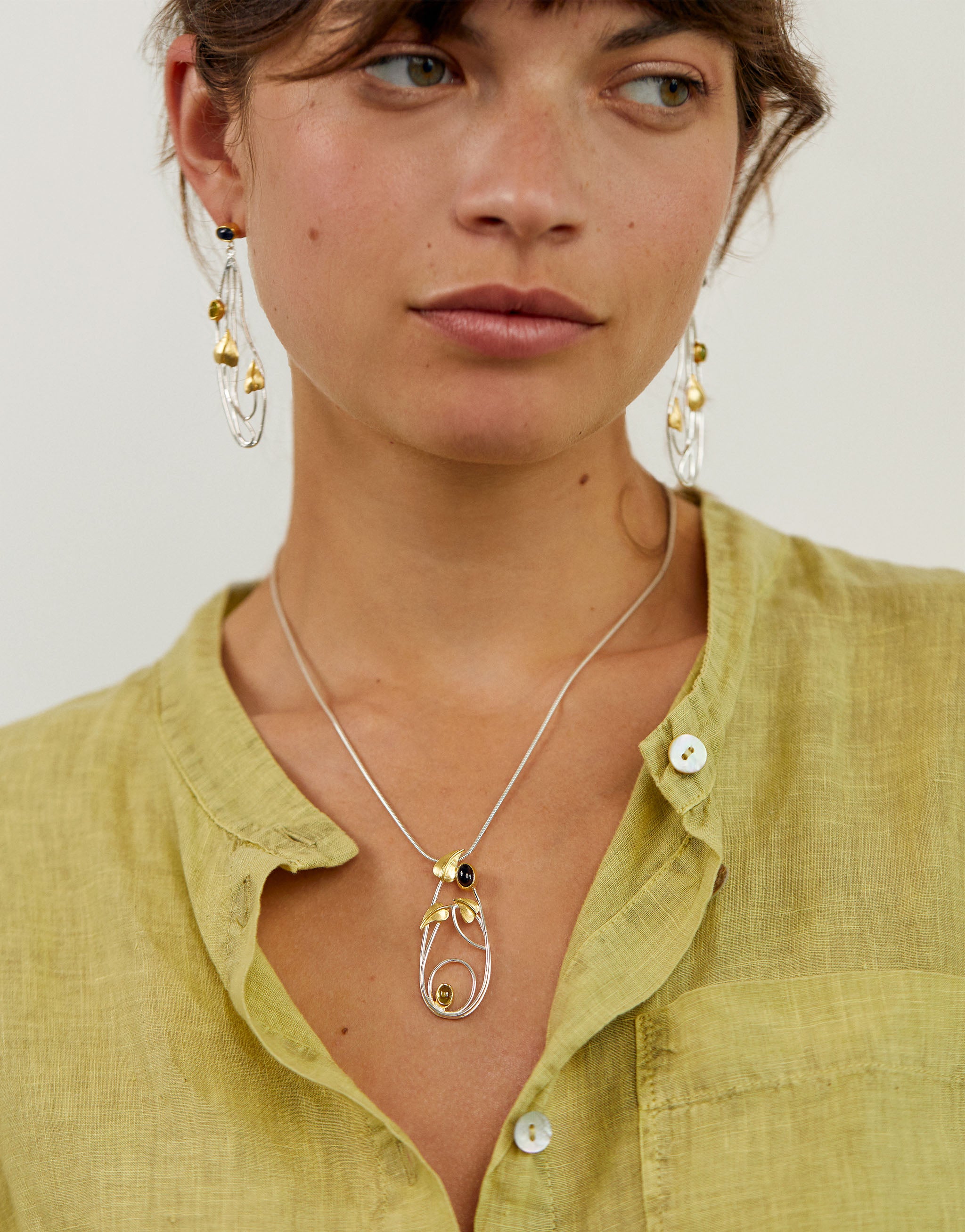 Art Nouveau inspired Macdonald set with silver necklace and drop earrings featuring iolite and peridot gemstones.