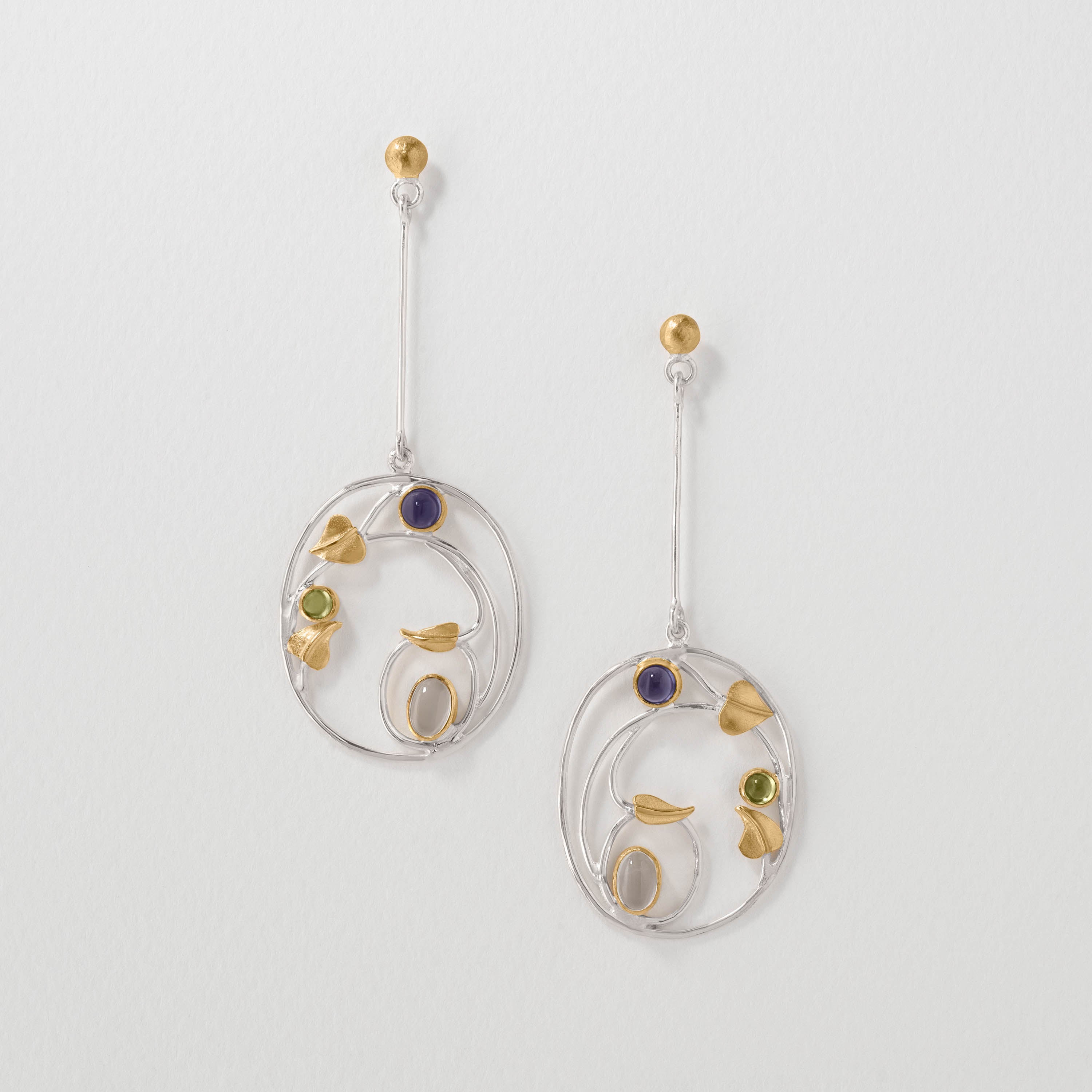 Willowwood drop earrings inspired by Margaret Macdonald, crafted in sterling silver with peridot and iolite. Elegant Art Nouveau jewellery reflecting her iconic Gesso panels and flowing organic style.