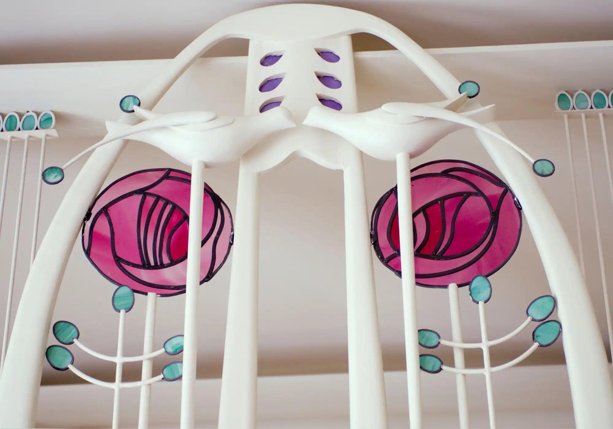 Detail of an Art Nouveau white piano with elegant, flowing lines in the House for an Art Lover, designed by Charles Rennie Mackintosh.