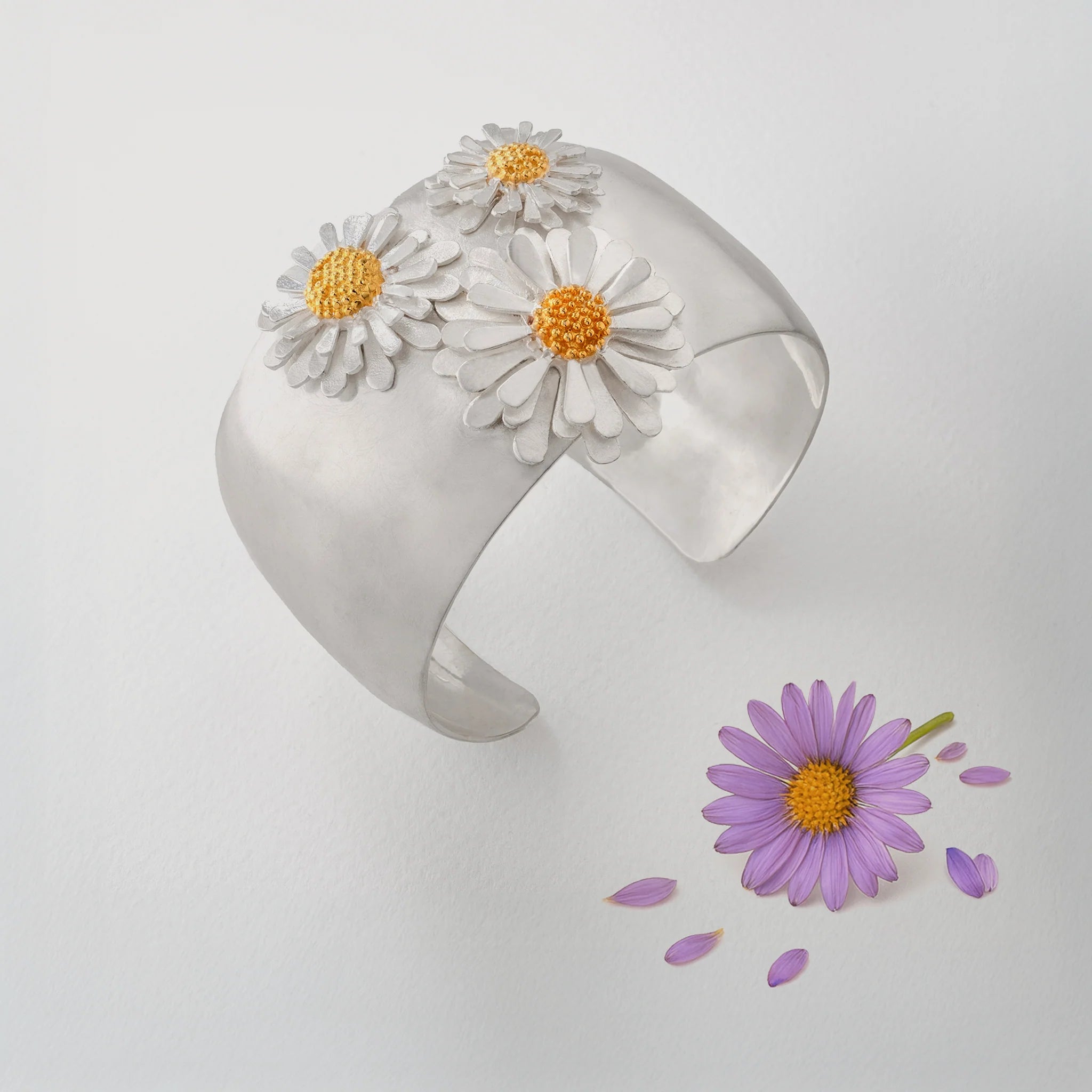 Birth flower jewellery by Paula Bolton feature a silver and gold aster flower bangle.