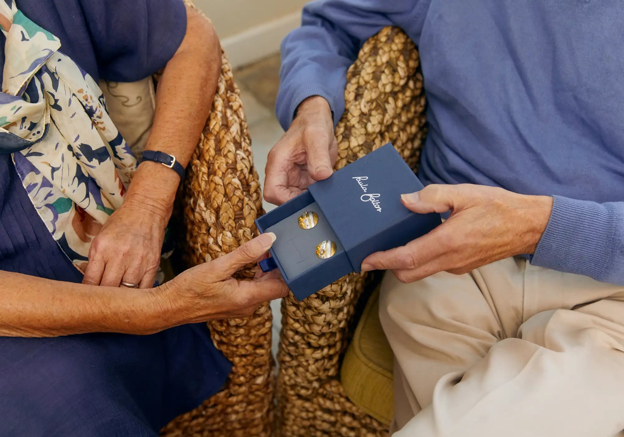 Picture of husband giving his wife a gift of  Paula Bolton Jewellery.