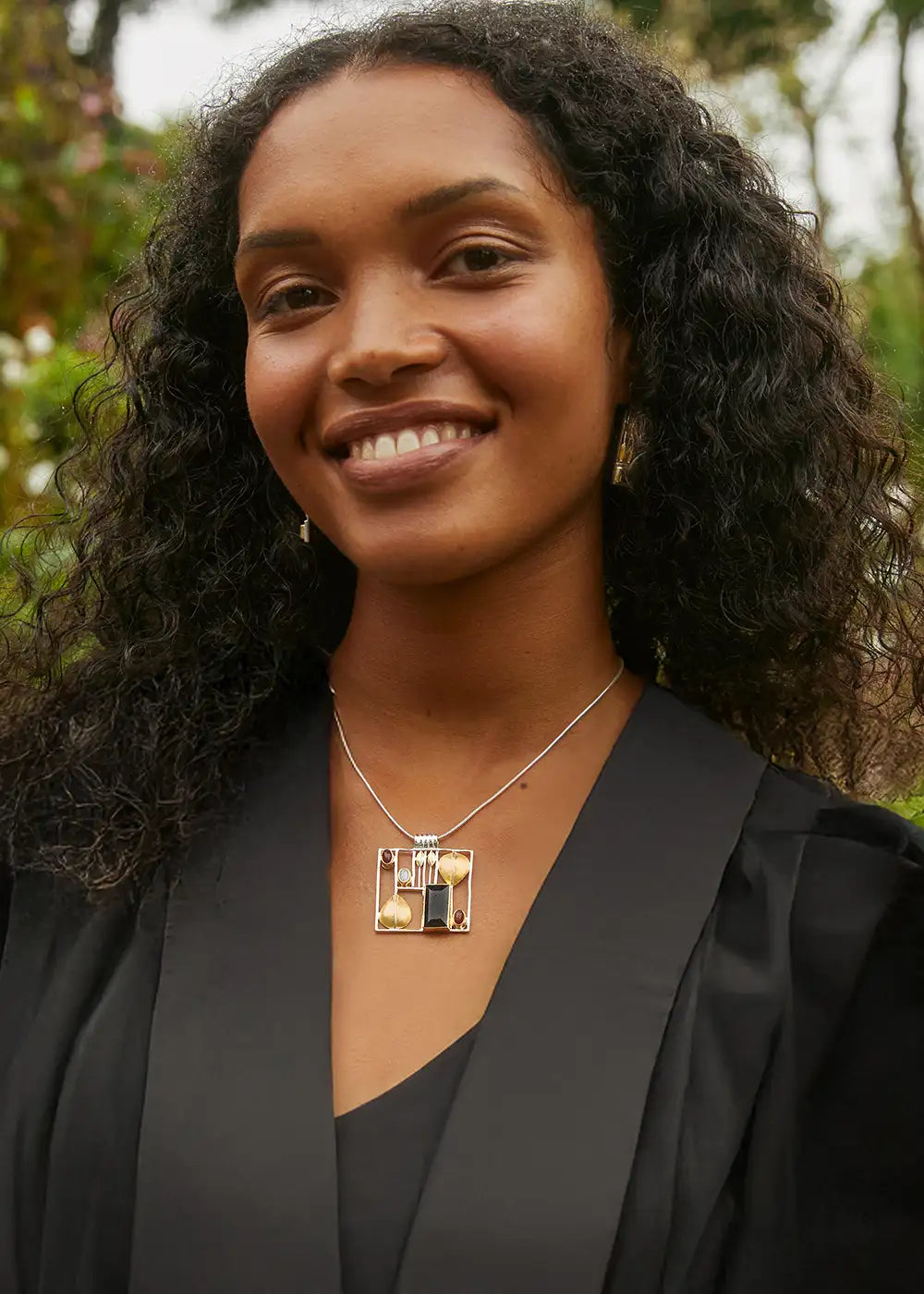 female graduate in gown wearing unique silver jewellery